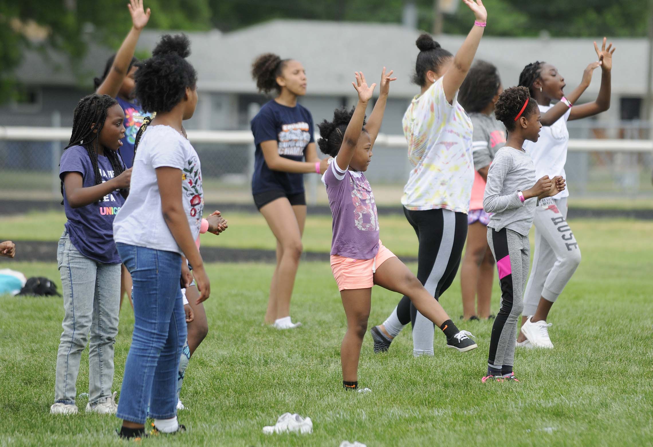  Participants in Haglers 12th Annual Kidz-Kan-Do Football and Cheerleading Camp practice a cheer routine Saturday on the football field at Bishop McNamara High School in Kankakee. The kids where taught various cheerleading skills throughout the day a