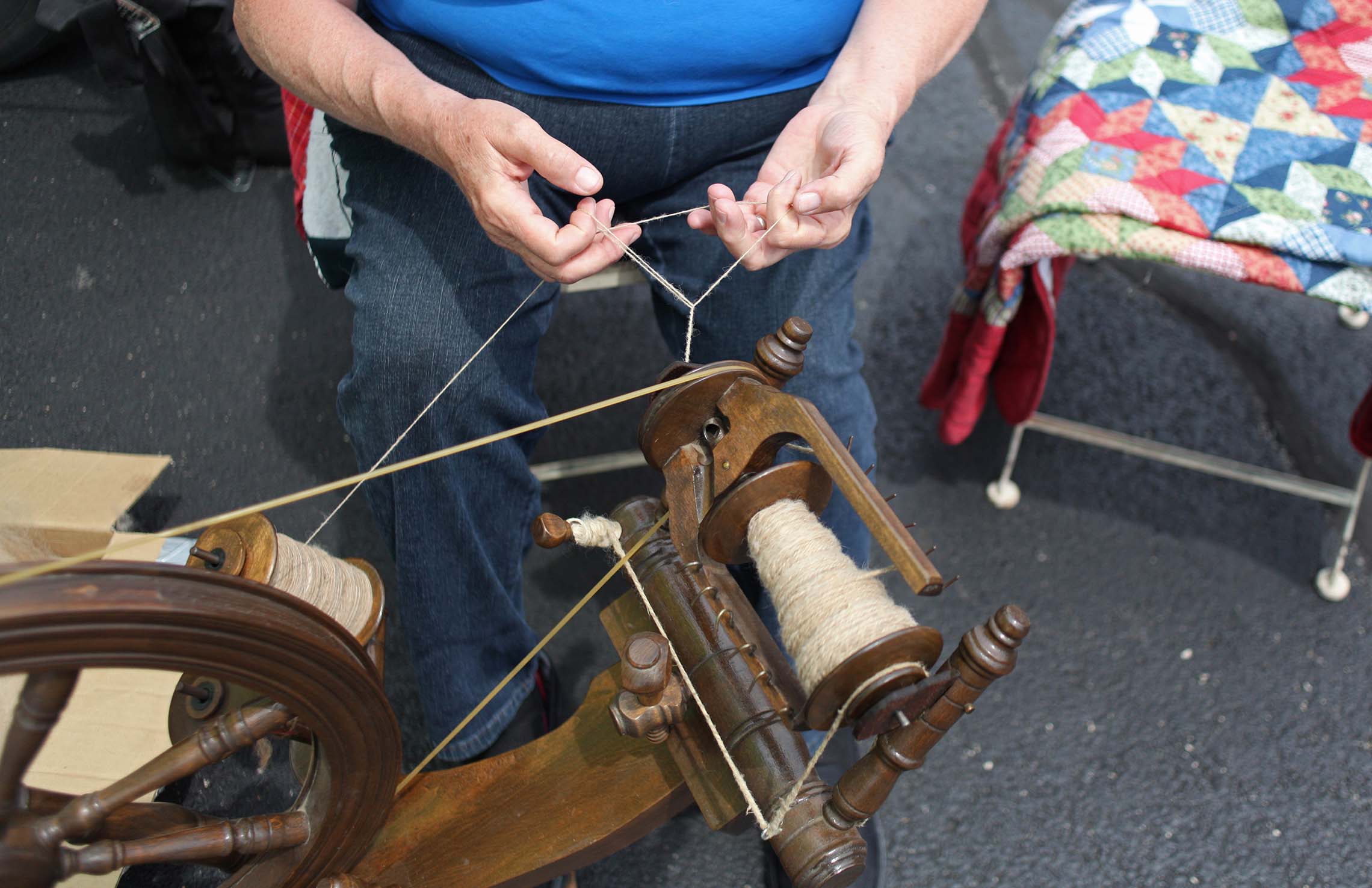  Rosie McHugh spins alpaca fiber into yarn Saturday during the Kankakee Farmers Market in downtown Kankakee. The alpaca fiber comes from the family farm and used to produce various items from yarn to socks and insoles. 