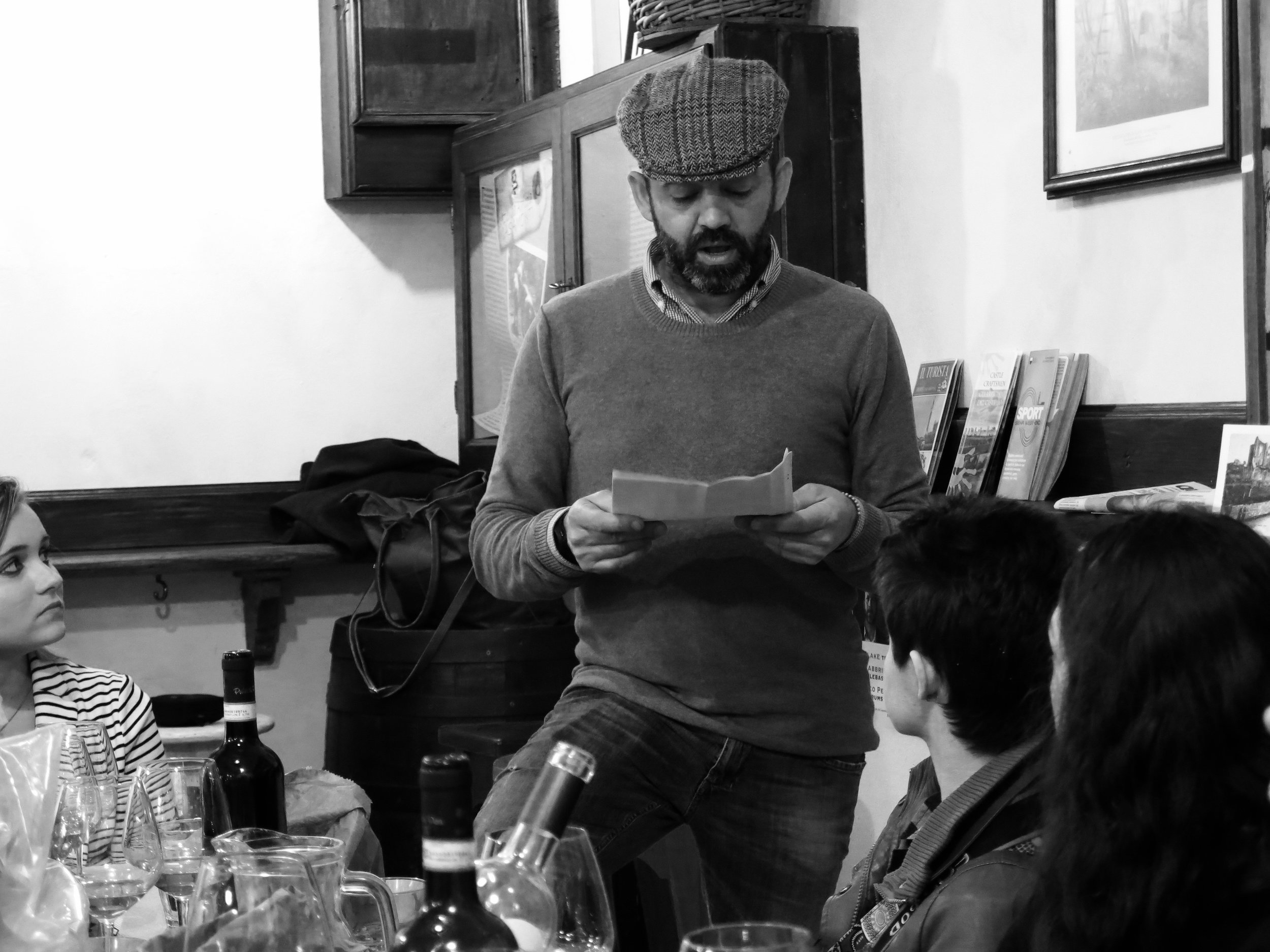 Emanuele, owner of Pretto Prosciutteria in Siena, reading his grandfather's poetry to our guests as they finish a mid-afternoon refreshment of local delicacies from the Chianti.