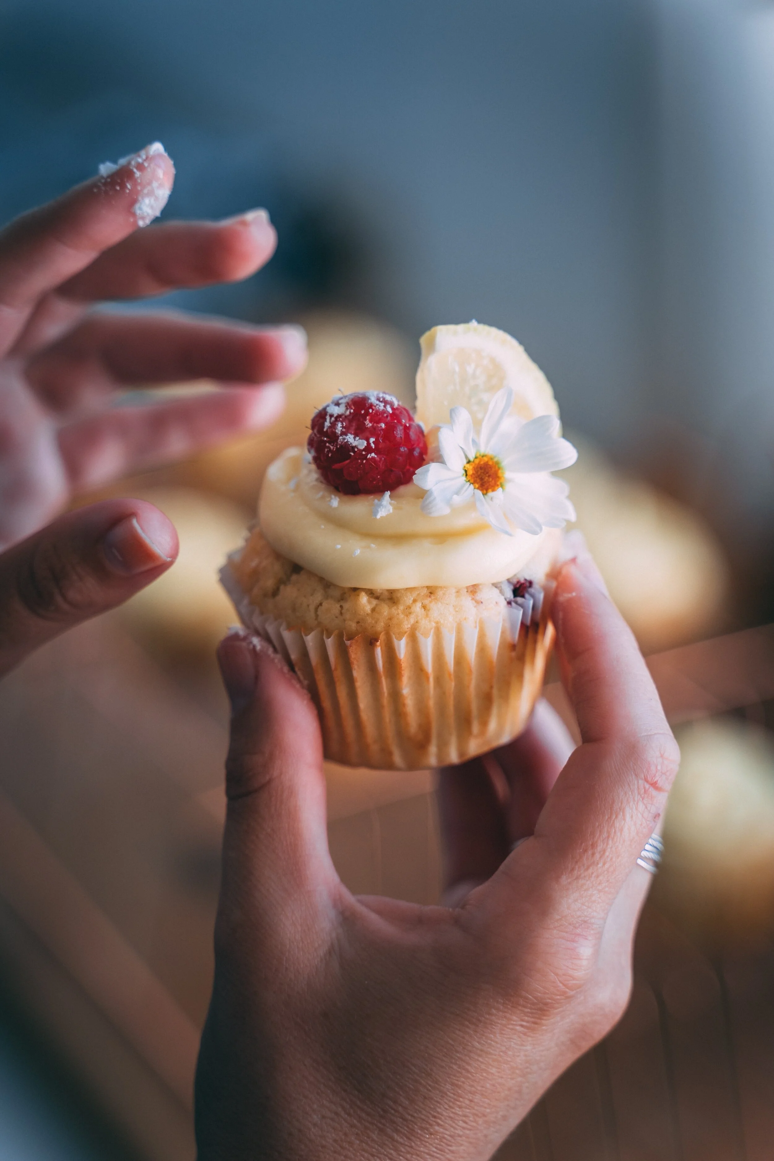 person-holding-cupcake-with-white-icing-4099127.jpg