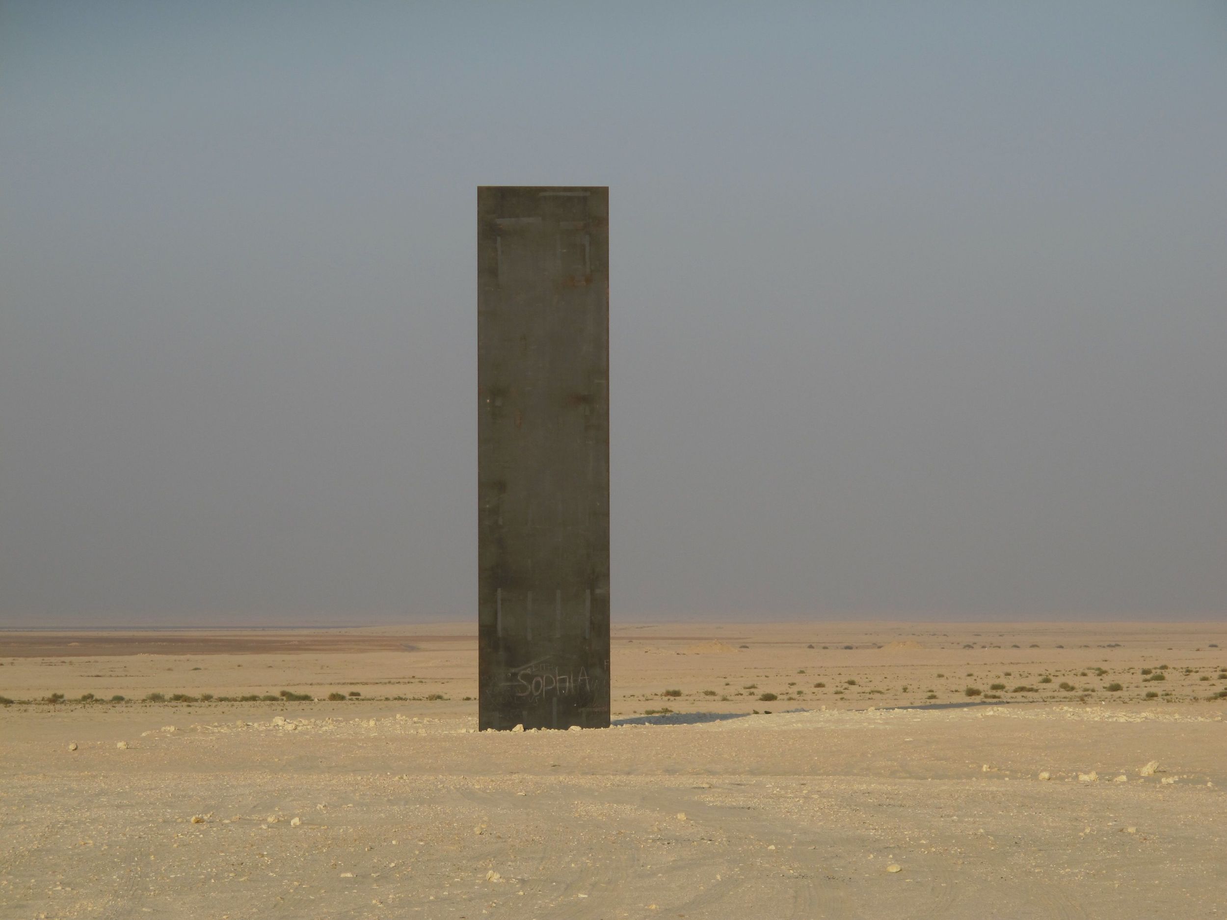 One of the four steel plates standing in a line in the Qatari desert