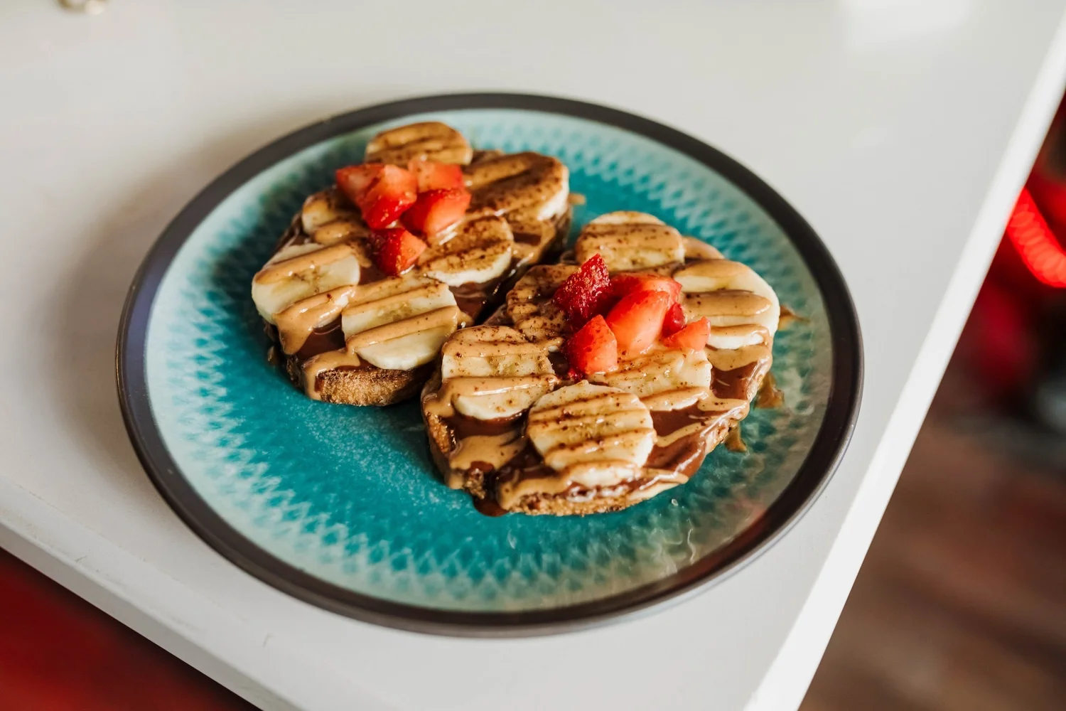 Banana and strawberry toast drizzled with nut butter