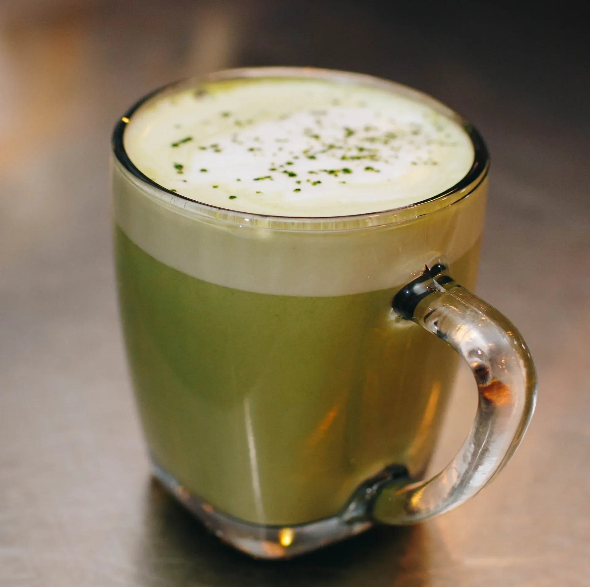 A vibrant matcha latte made with ceremonial-grade green tea and creamy milk, topped with a light foam and matcha dust. This cozy, antioxidant-rich drink from Raleigh Raw highlights pure ingredients and smooth, earthy flavor.