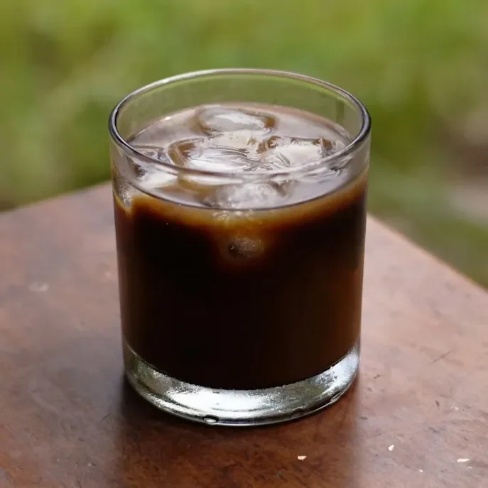 Refreshing cold brew coffee served over ice in a clear glass, showcasing its rich, smooth flavor and slow-steeped depth. A clean, minimalist drink shot highlighting Raleigh Raw’s bold, naturally crafted cold brew.
