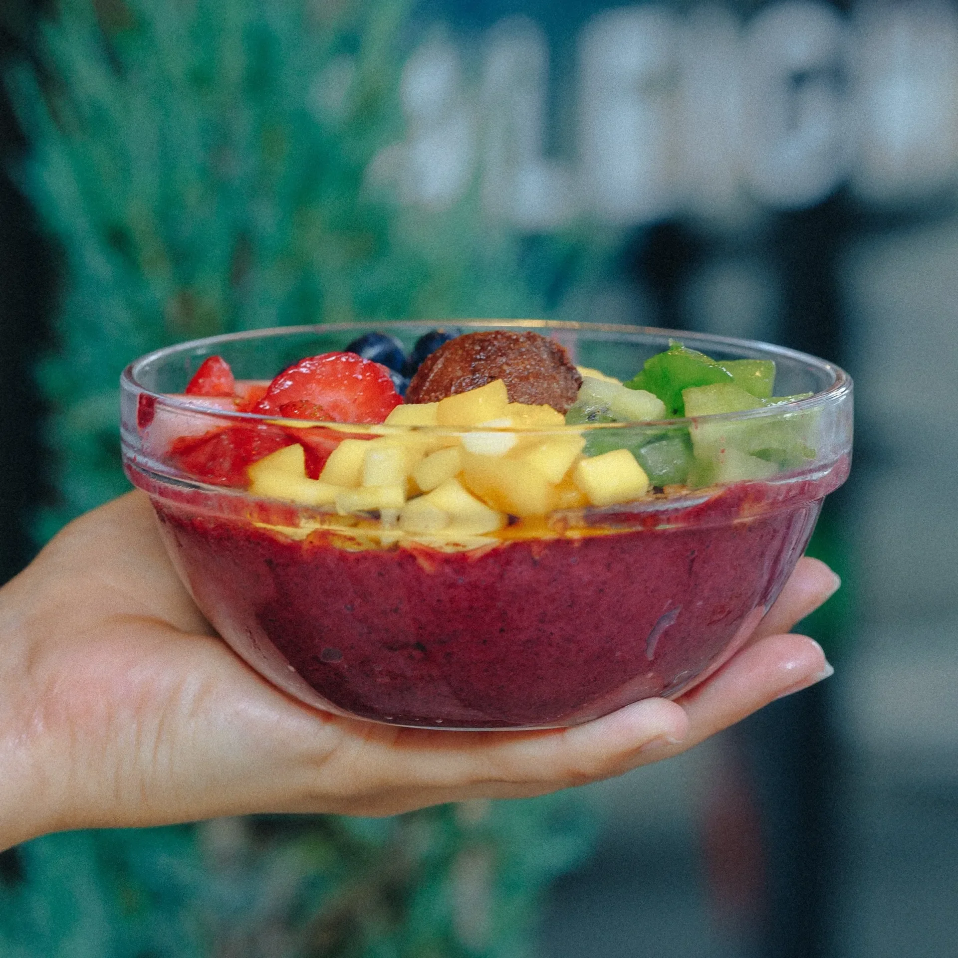 pineapple, berries, passion fruit, dragon fruit, açaí, and avocado into a vibrant base, topped with granola, chocolate cashew butter, strawberry, kiwi, mango, blueberry, chia, and bee pollen for the ultimate superfood bowl