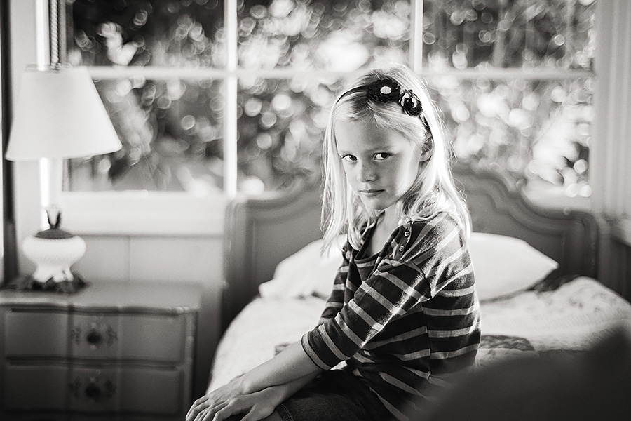 This portrait of Jorryn, made with a 50mm f1.4 Zeiss lens was shot at f2 and again shows the signature highlights or bokeh that I have come to love with the Zeiss branded lenses. And, because it's a 50mm focal length there's enough detail of the scene (here showing one of the historic Crystal Cove cottages where the family was vacationing). 