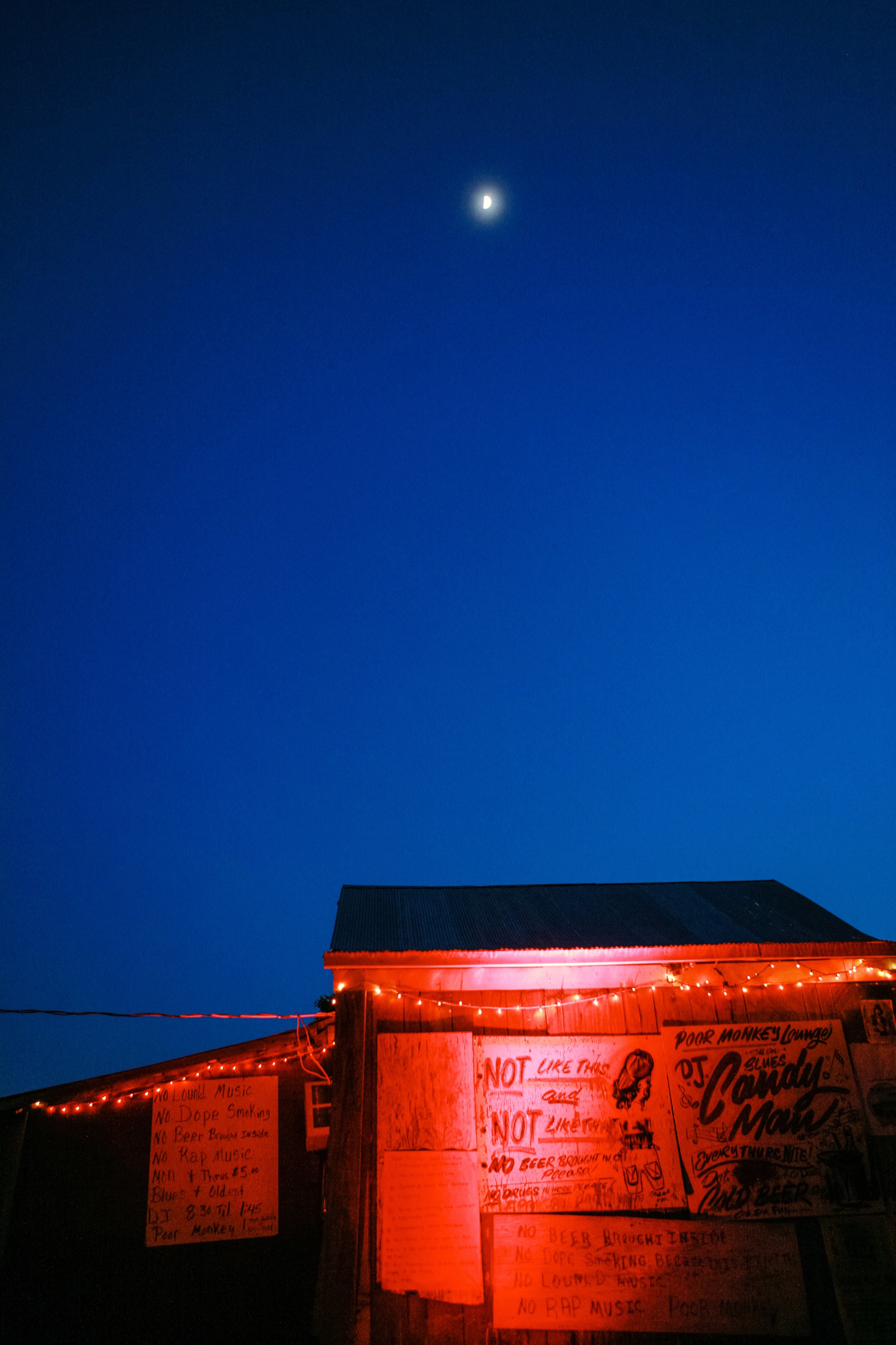 The moon rises above Po' Monkey's juke joint during the night of Kate and John's Mississippi Delta Wedding.