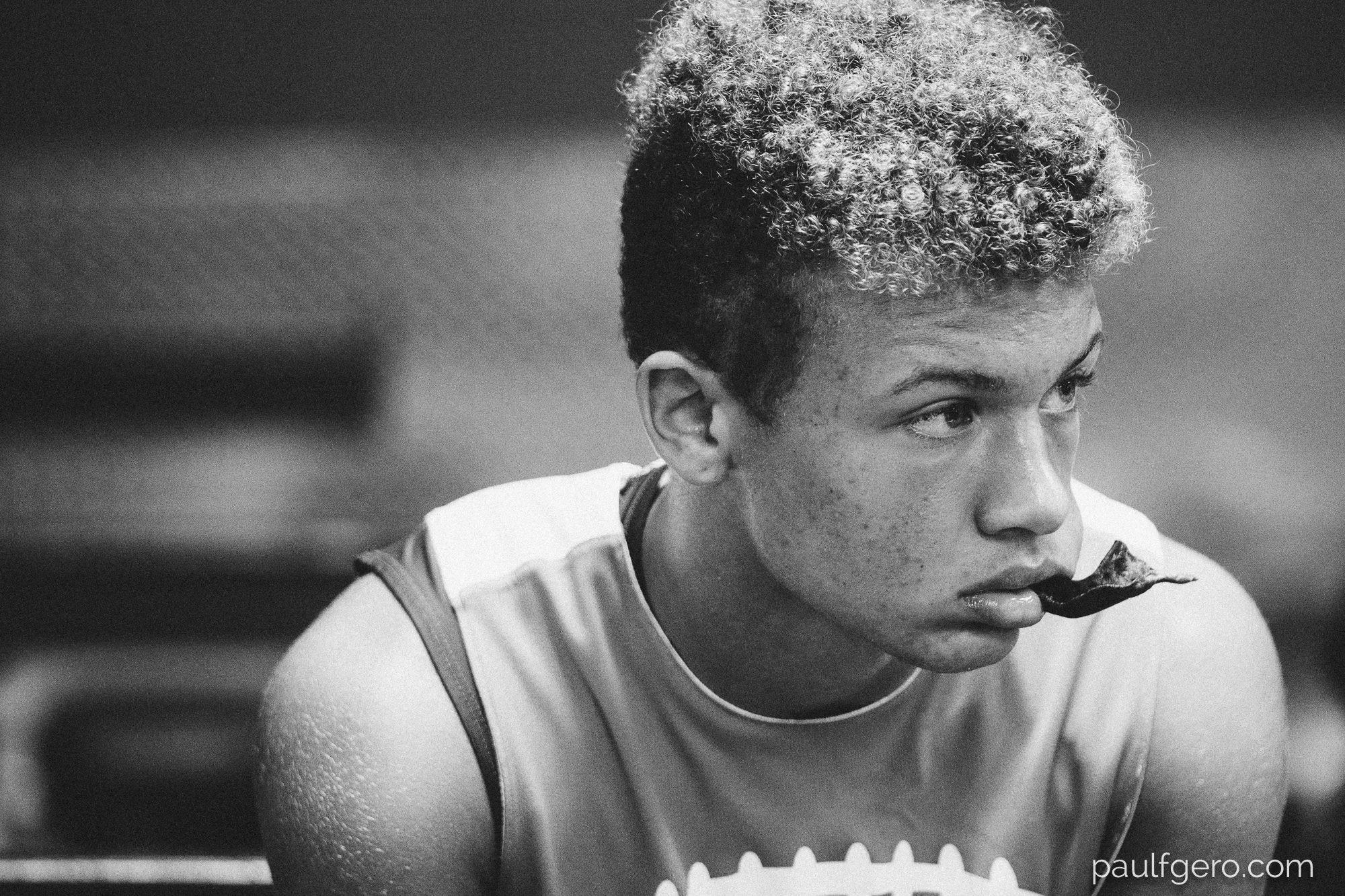 A Tesoro player listens to head coach Matt Poston in the school's weight room just after 7:30 AM on Monday. 155mm, 1600 ISO, 1/60th at f2.8.