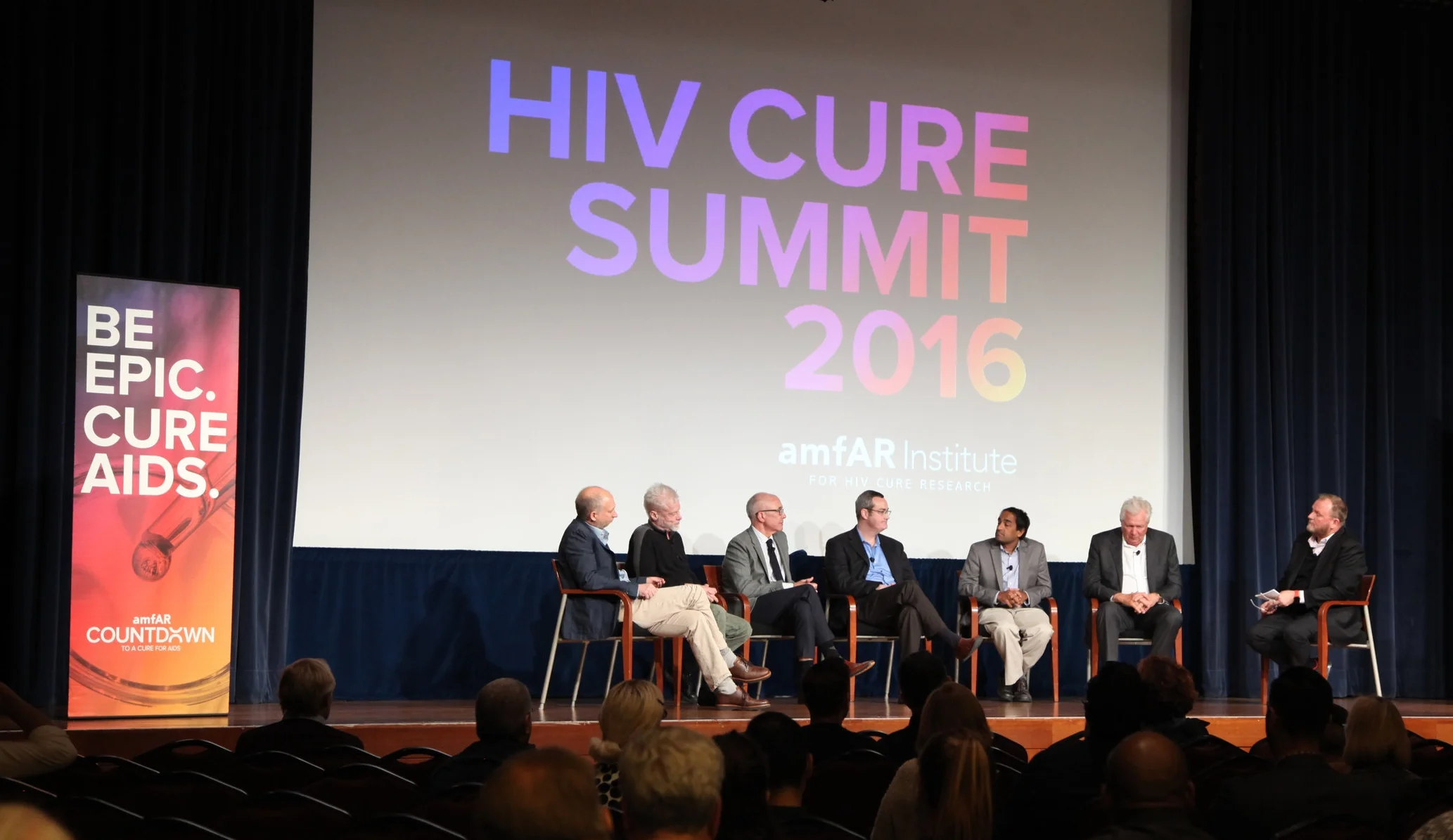amfAR CEO Kevin Robert Frost (right) moderates the panel discussion.
