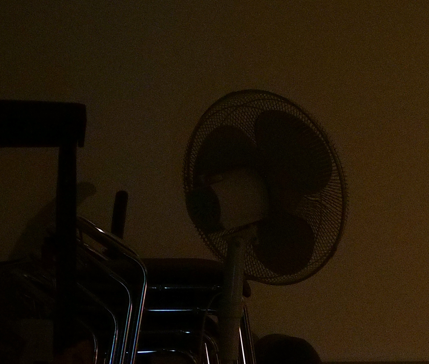 Here is a 1:1 crop of the fan in the background (click to see bigger). You can even see its individual little spokes on the fan. At 1/10 second, this is more of a testament to Olympus's amazing 5-axis image stabilization at work. Again, Noise Reduction turned off is my preference to preserve detail; I"m not sure this detail would be present if it were turned on in the camera.
