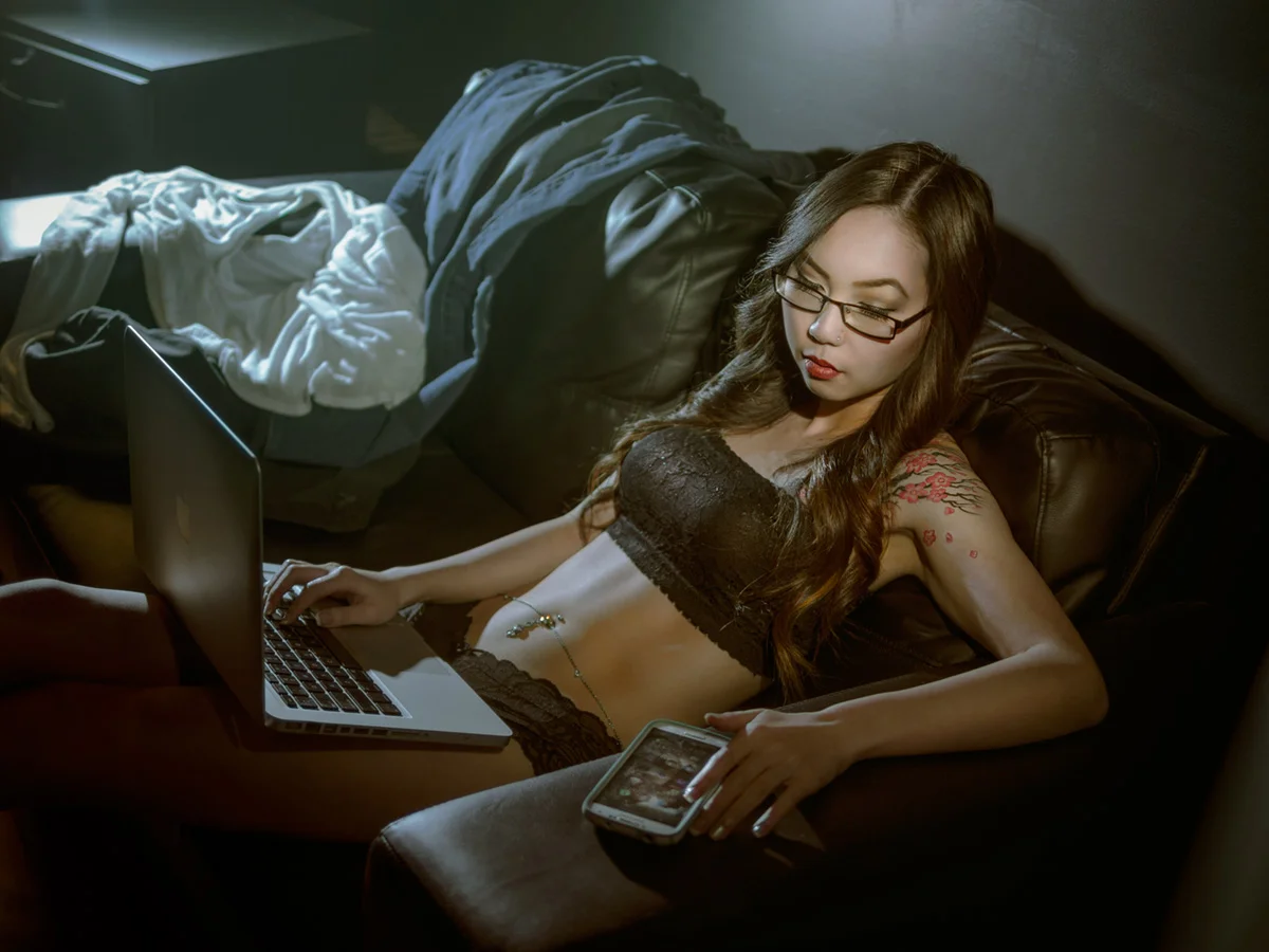 Sexy Studying: shot with the Lumix 25mm/1.4 lens at f/1.4. KEY light is: speedlight in an Orbis ringflash adapter just camera right. Backlight is speedlight with a Honl 1/8 grid. Color temp in-camera turned down to cool, but the speedlight in the Orbis has a warming gel on it.