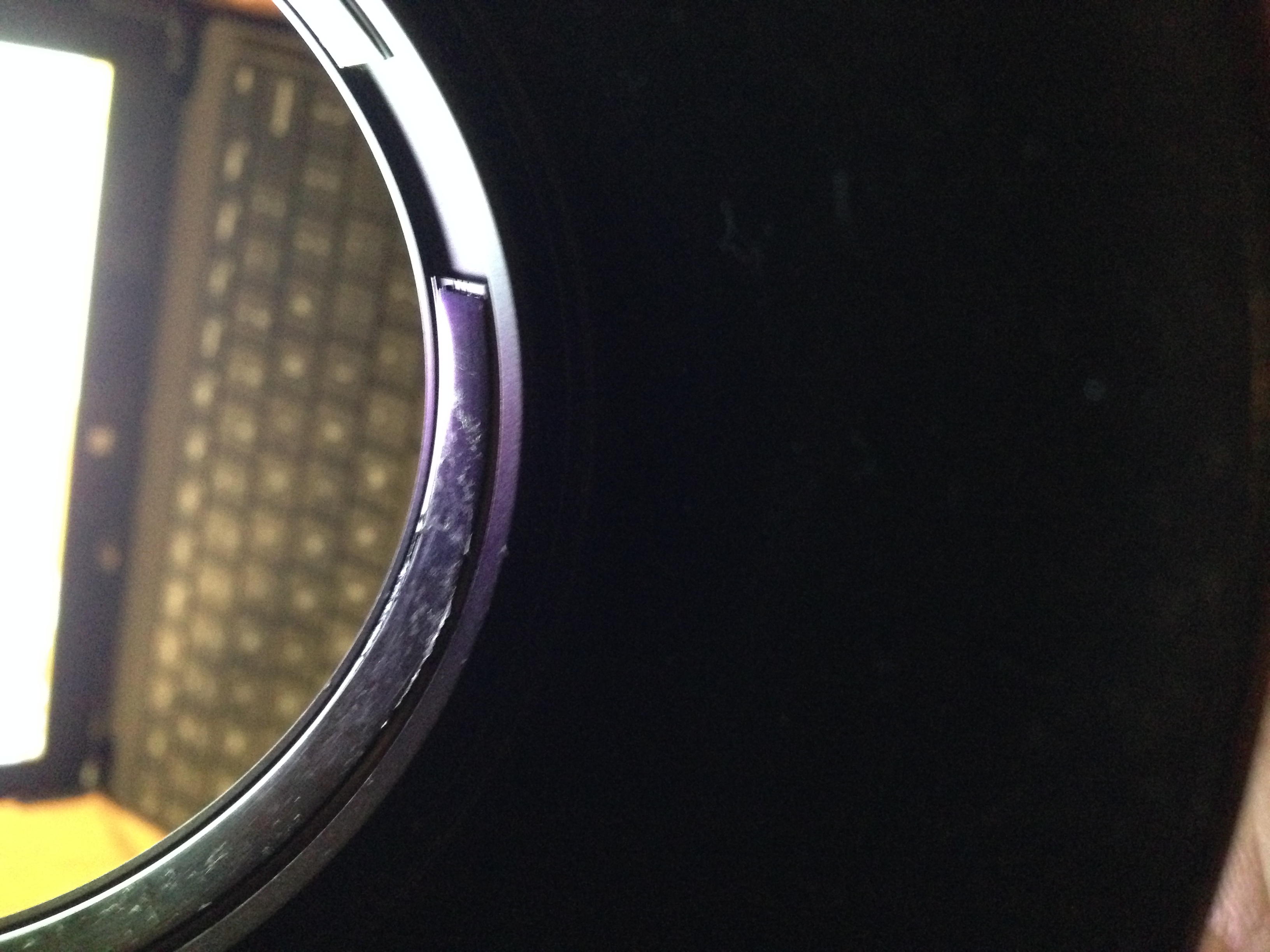 Different light: see those "scuff" marks? Those are actually glue residue. The glue would seep out from under those "strips" over time and onto the lens barrel. Pulling the hood on and off the barrel left extra residue back on top of the "strips."
