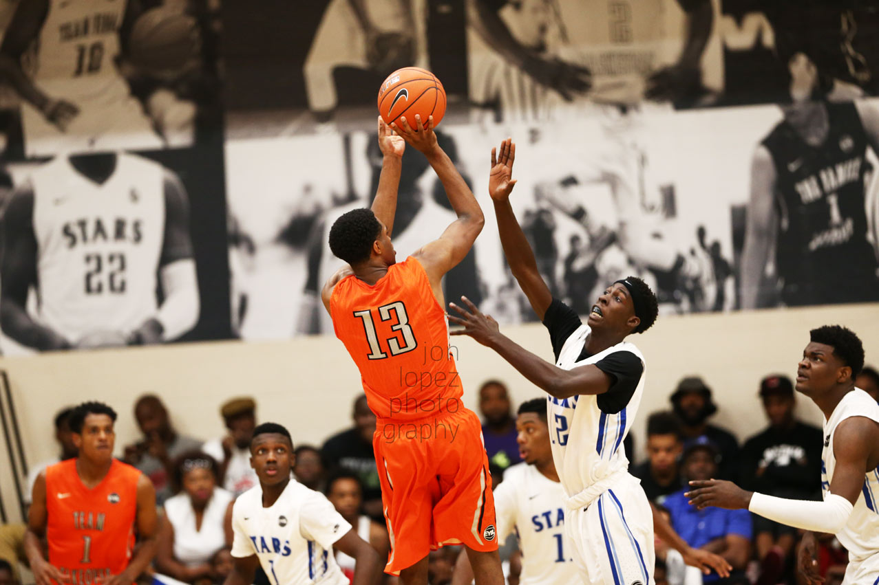 VJ King pulls up for a jumper during the Peach Jam final four. I was hyped to see my images from the EYBL season printed so large in the background. 