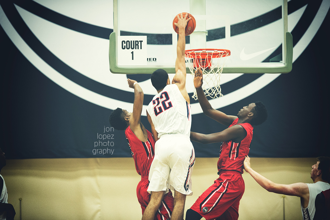 Jayson Tatum rises up for a dunk attempt over two defenders at session 4 of the EYBL in Minneapolis, MN. 