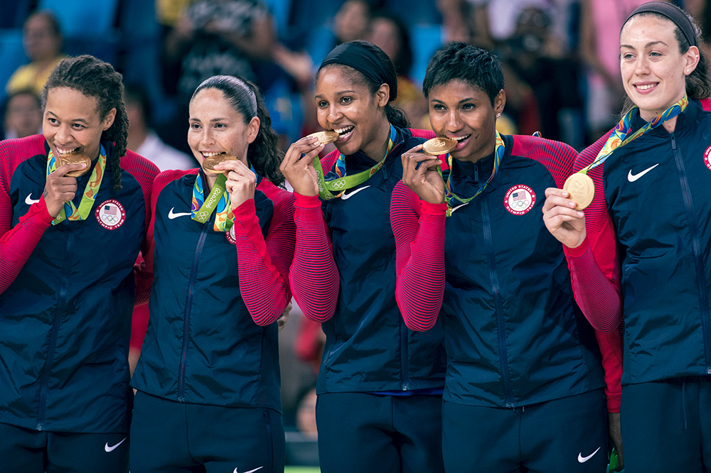 Team USA bites into their gold medals in Rio. 