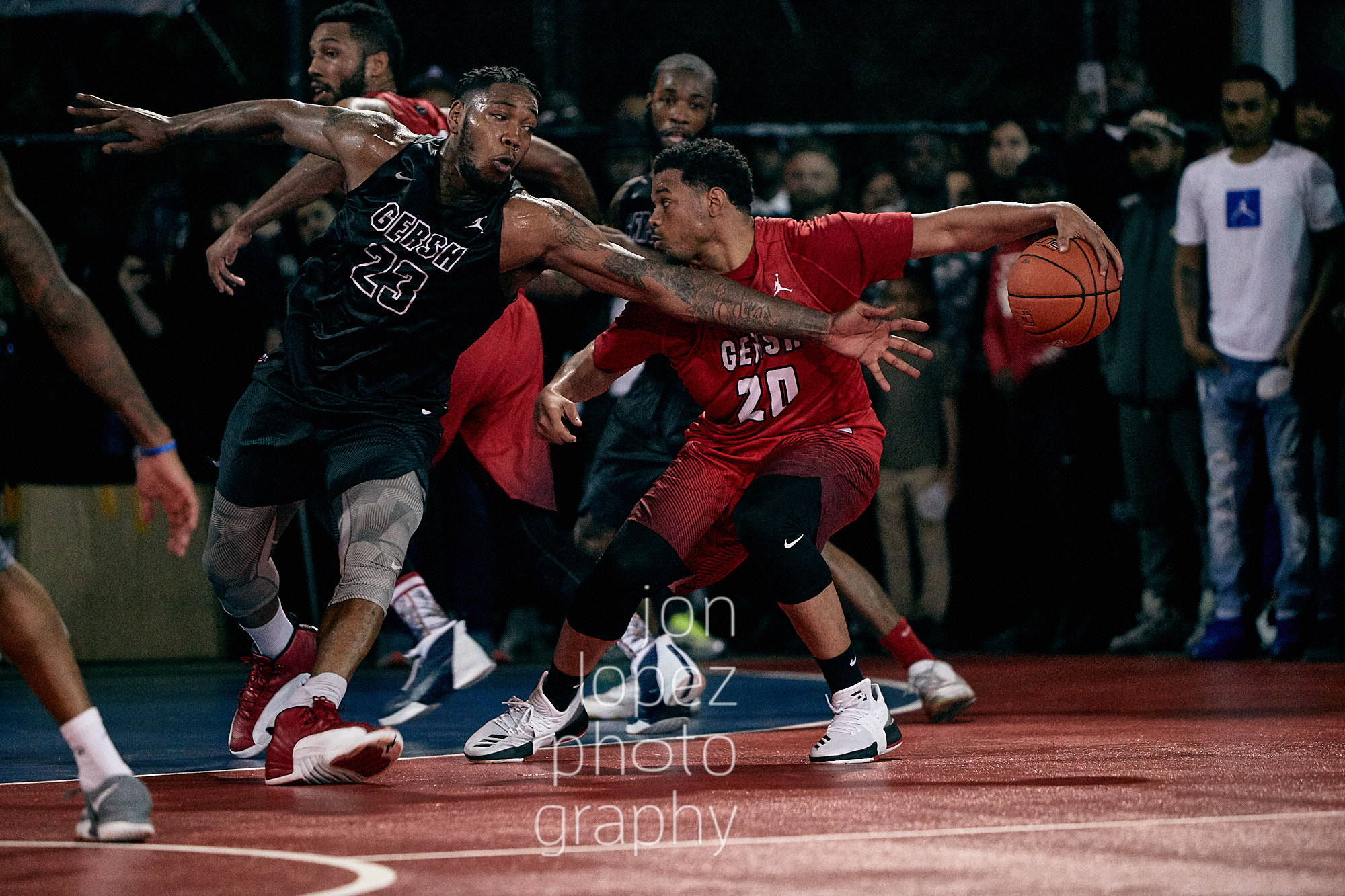 Corey Fisher of the Sean Bell All-Stars puts a move on Kinu Rochford of the Brooklyn Stompers at Gersh Park on opening night. 