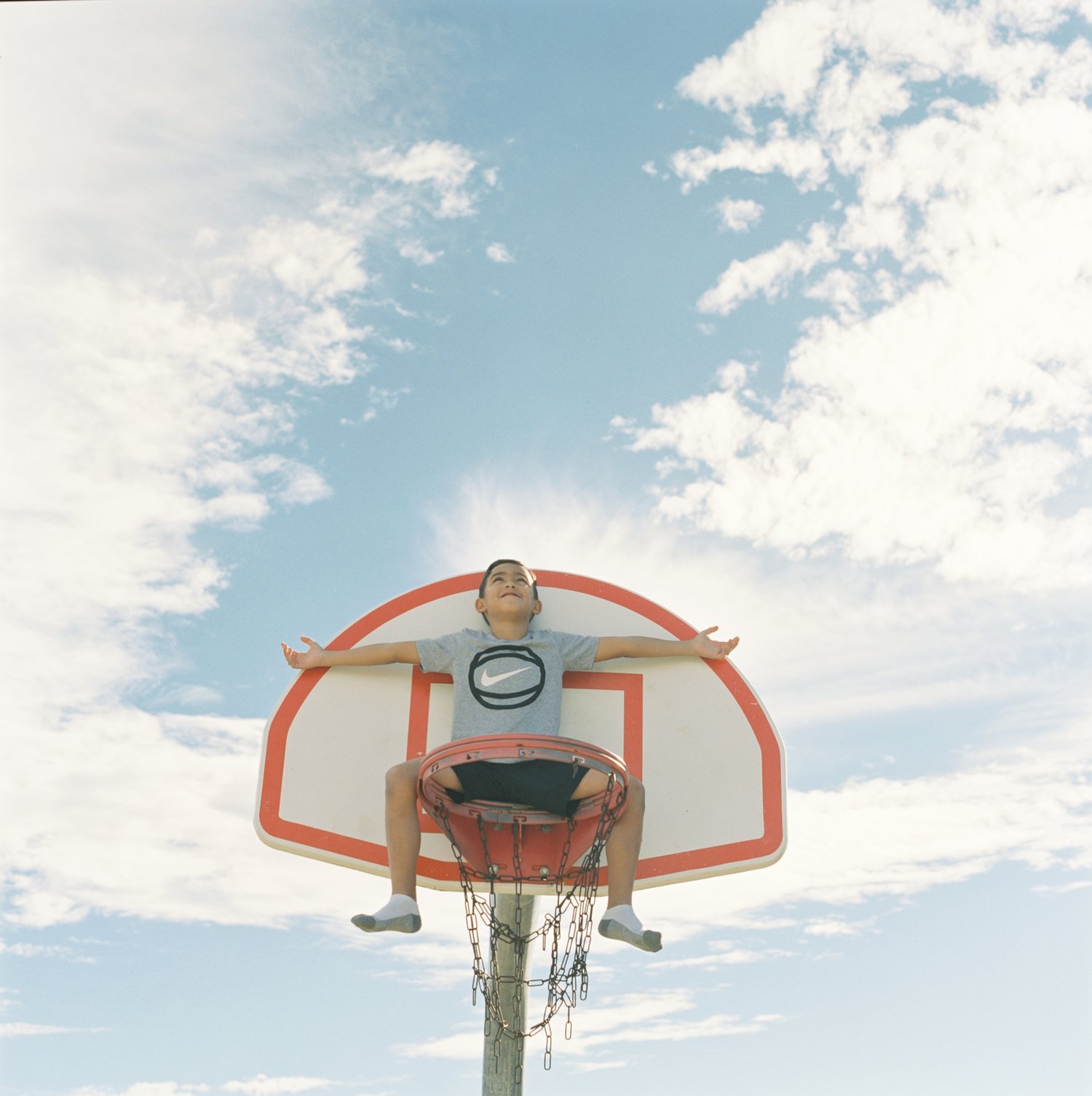 Sebastian sits on the basket in the sky. Dallas, TX 2017. Shot on a Hasselblad 501cm with Fuji Pro 400h film.&nbsp;
