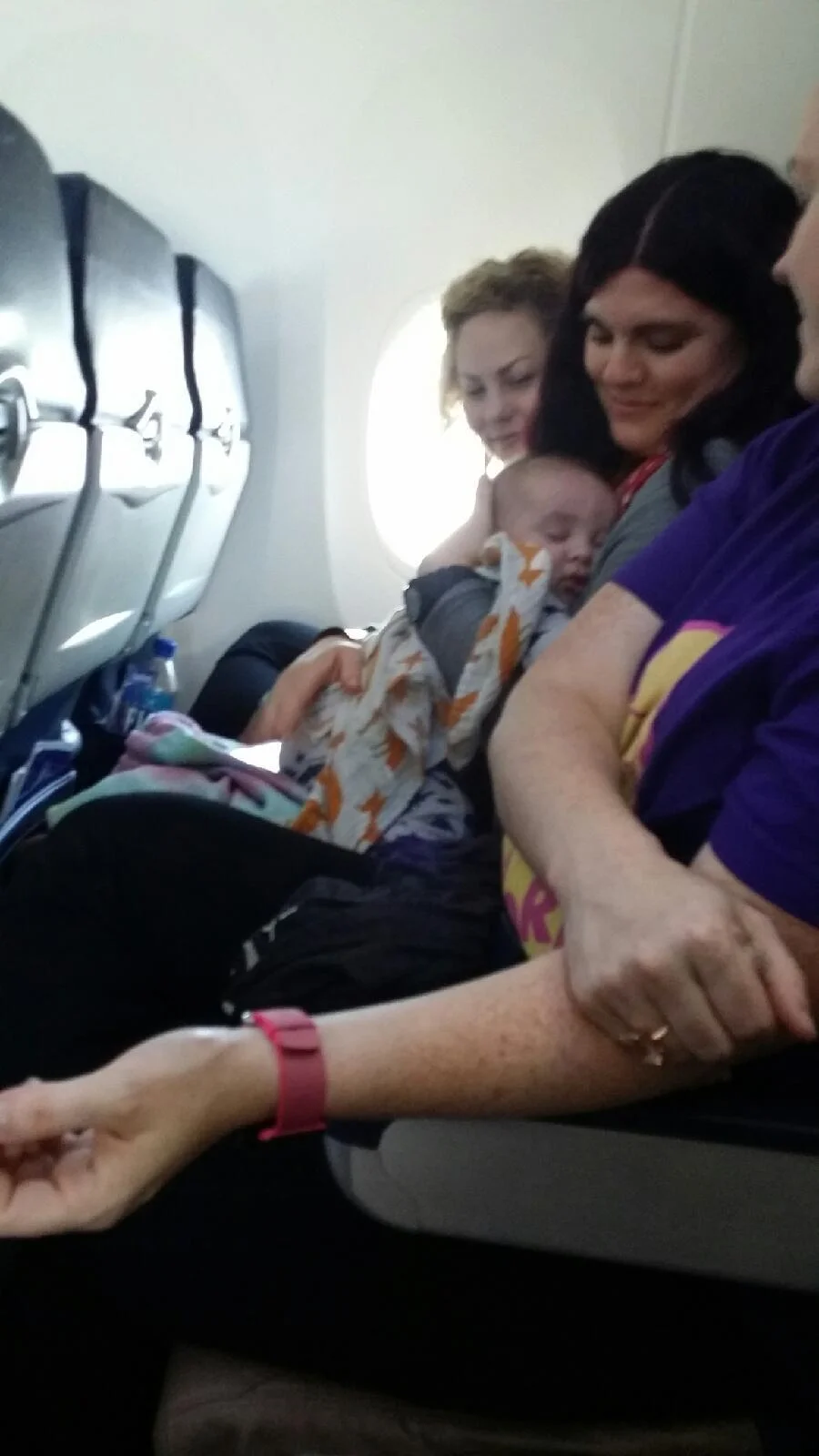 Holding sweet baby Dash as he sleeps, while his mama holds his sister. 