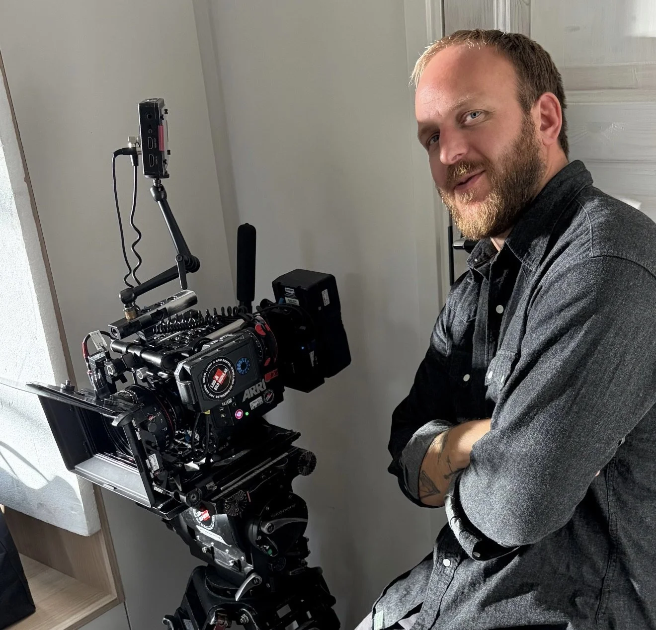 Stellan Runge FSF on set beside an ARRI cinema camera.