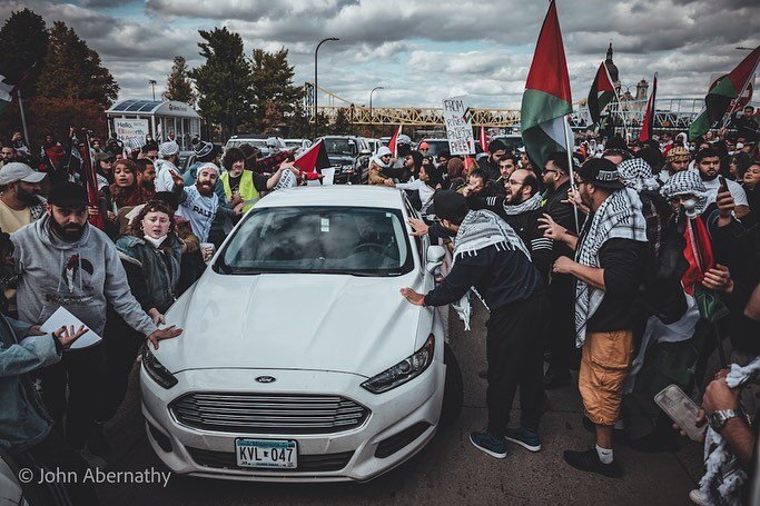 Thousands turn out for a pro Palestine protest in Loring Park to protest the war on Gaza. During a die-in protesters were lying in the blocked off streets. A man exited this white vehicle with a knife in hand. He was sprayed with mace and drove off t