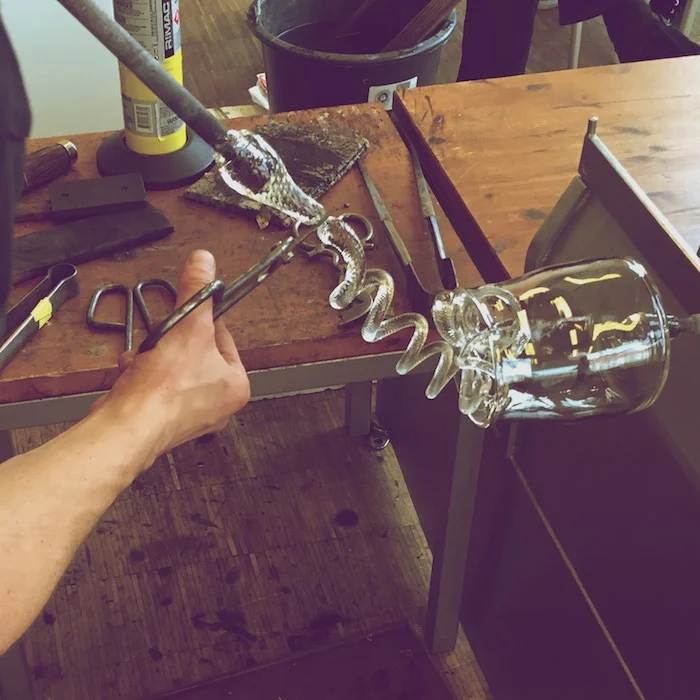 applying sculpted glass to blown glass
