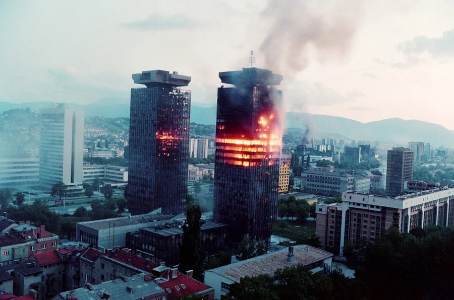 The "Momo" and "Uzeir" towers burn on Sniper Alley in downtown Sarajevo on June 8, 1992 (Getty)