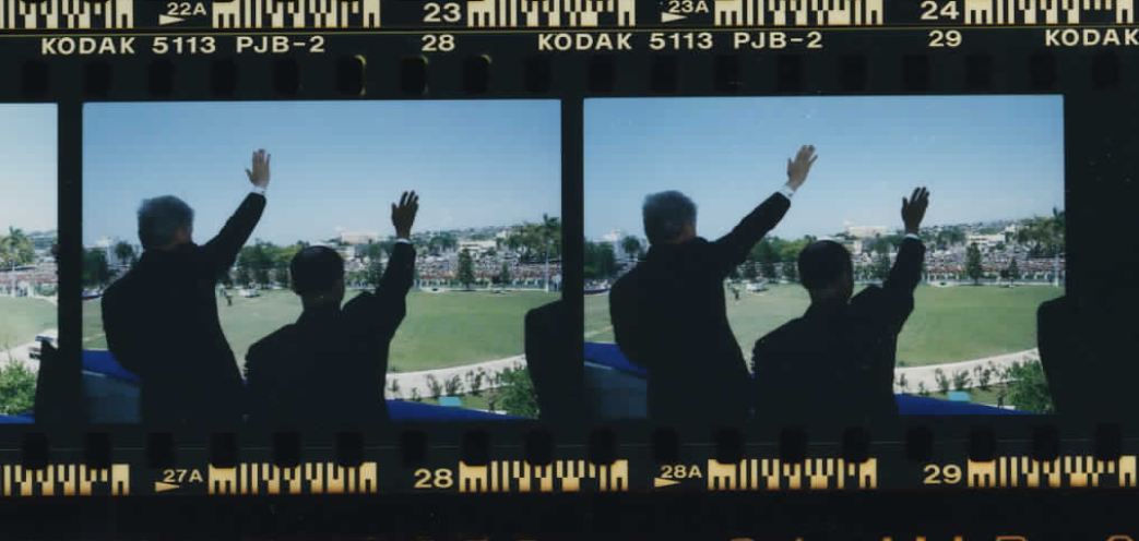 President Clinton and Jean-Bertrand Aristide waving at Haiti's National Palace on March 31, 1995 (Photo sheet: P026006)