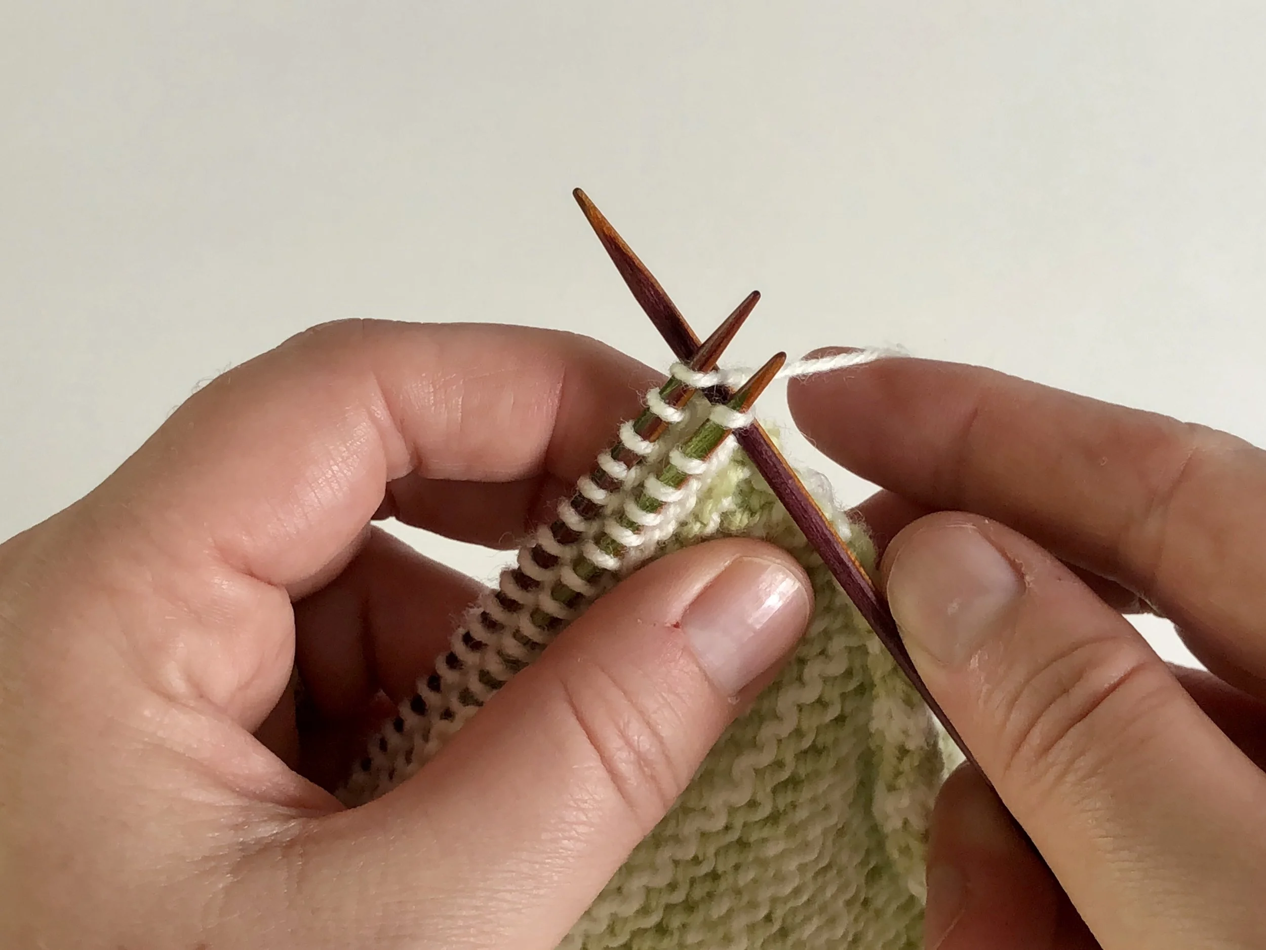 insert rh needle into first stitch on front and back needles