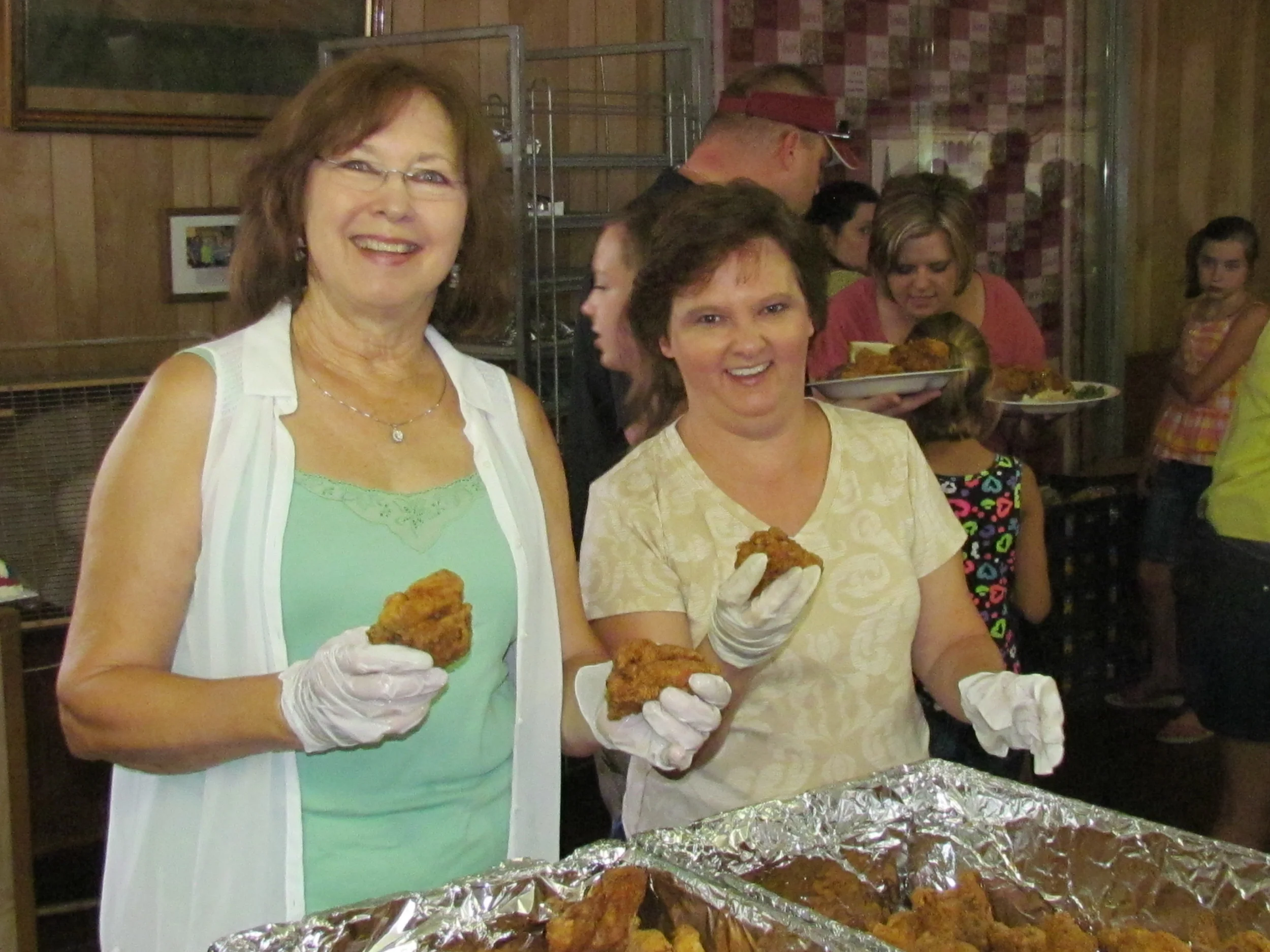 Earline and daughter, Cheryl, serve fried chicken at St. John's Picnic./Gary E. McKee photo