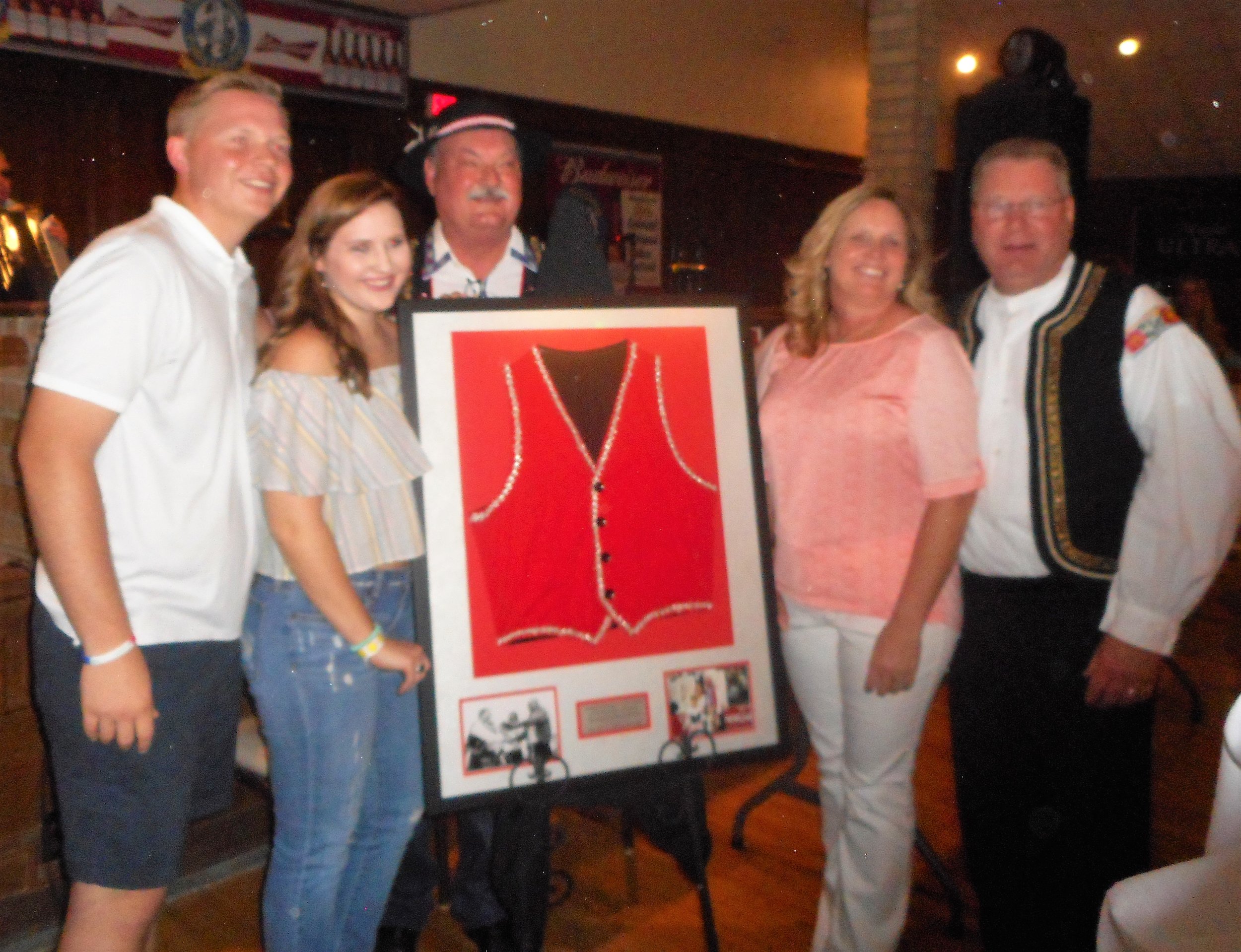 DZ, surrounded by family, was honored at 2016 National Polka Festival for serving as director. Former Ennis mayor Russell Thomas presented DZ with a framed vest that belonged to his dad.