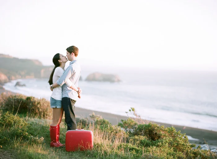 Sylvie-Gil-Engagement-Film-Photography-couple-red-rainboots-suitcase-vintage-kiss.jpg