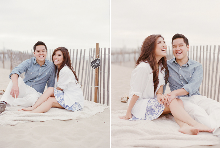 Couple relaxes on a blanket in the sand at Hermosa Beach during an engagment session with Sylvie Gil.