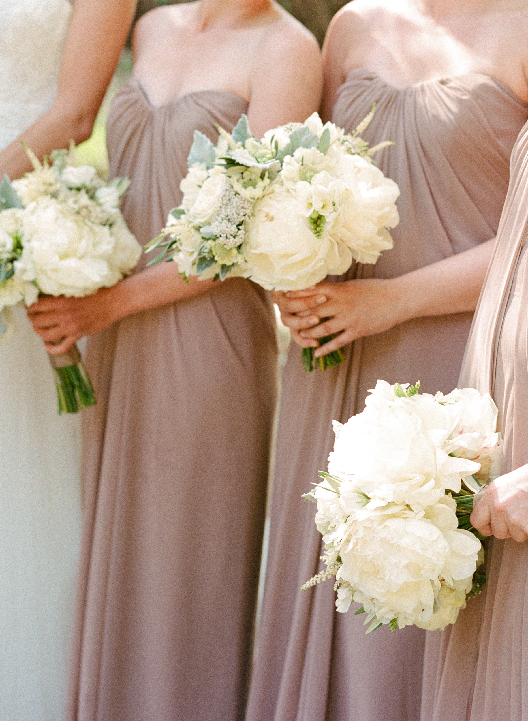 Bridesmaids hold matching white and green peony bouquets; Sylvie Gil Photography