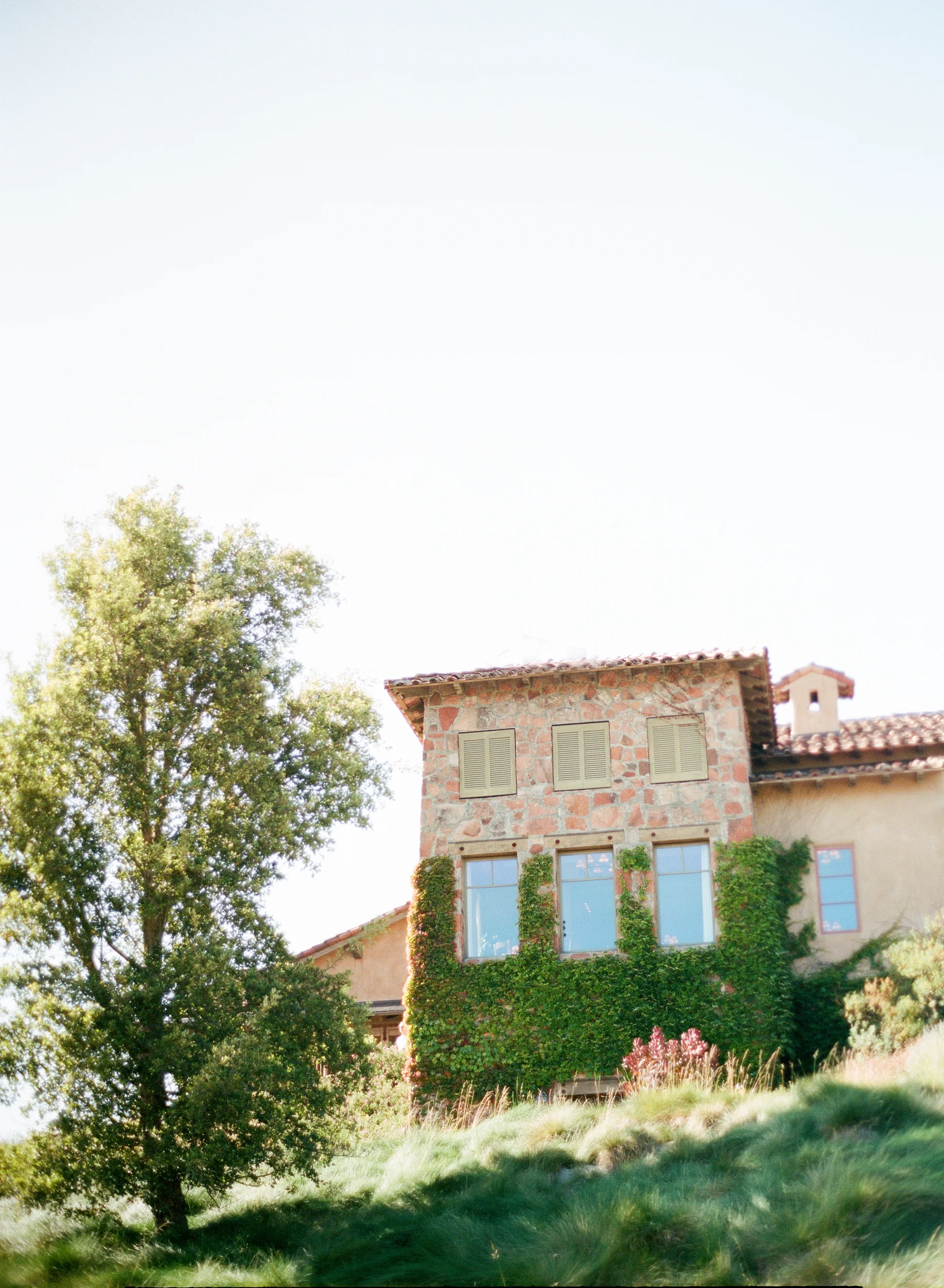 Tuscan winery building overlooking ceremony area in Calistoga Ranch; Sylvie Gil Photography