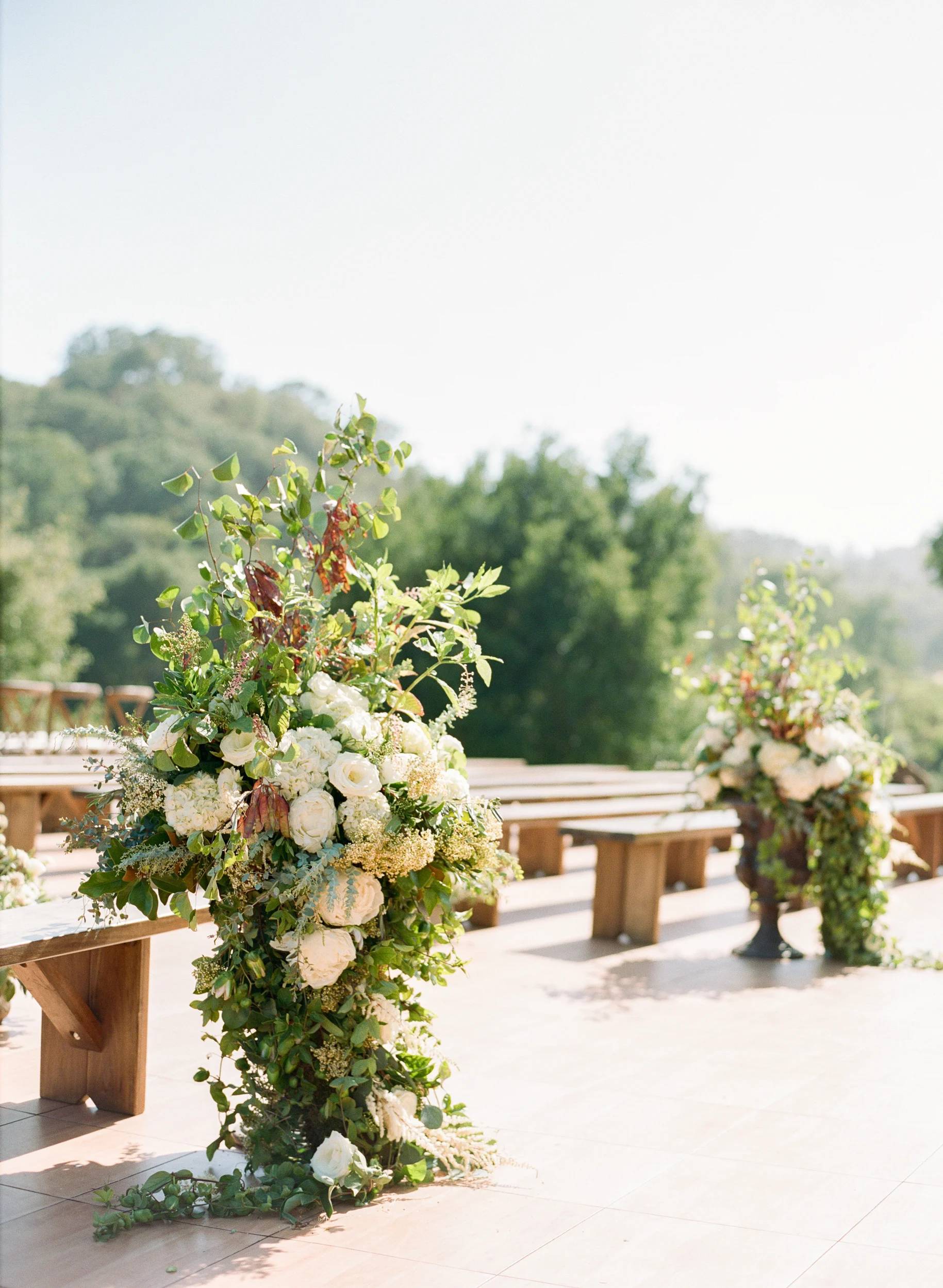 Cascading floral peony floral arrangements in ceremony area; Sylvie Gil Photography