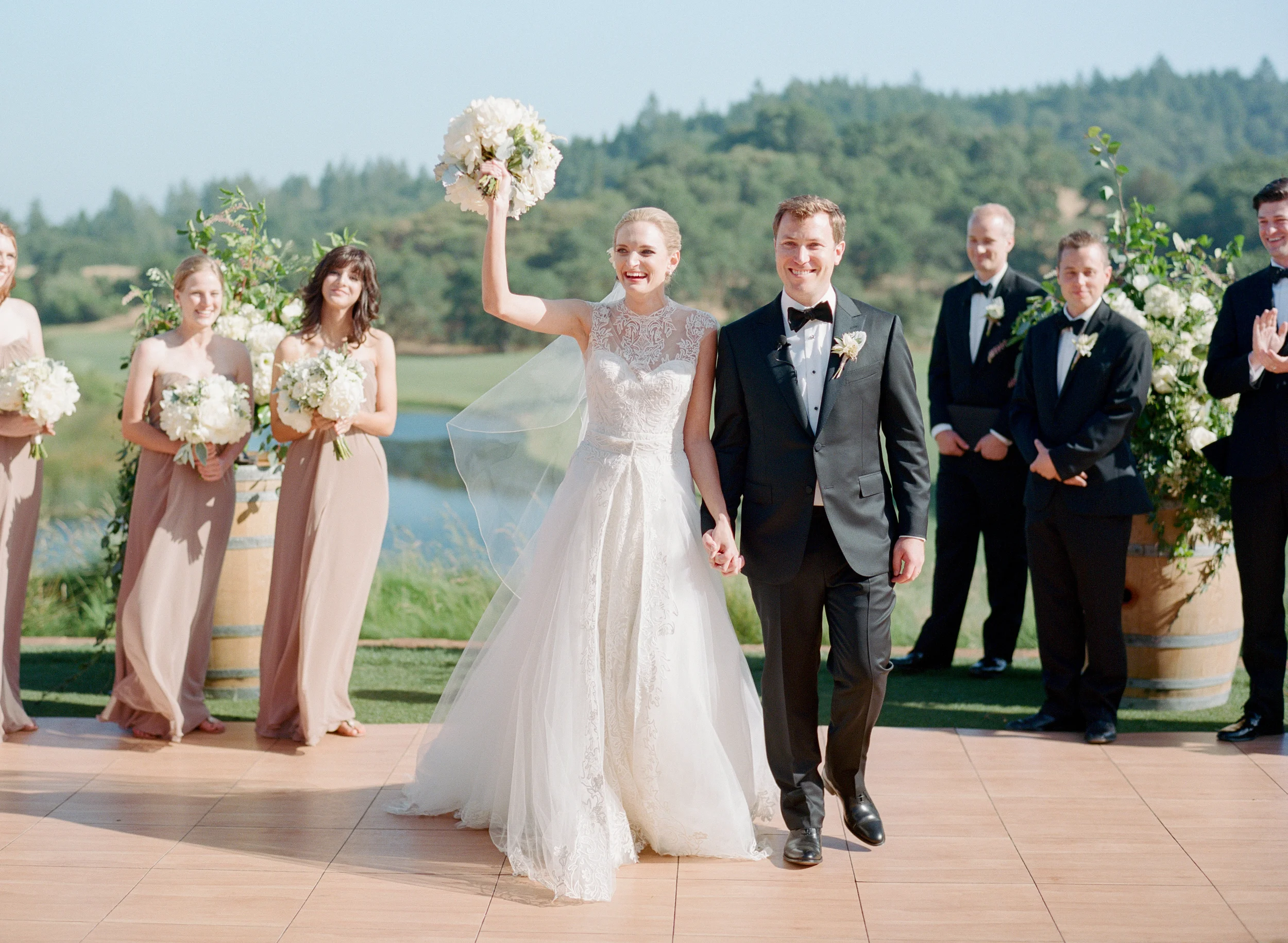Just married couple, bride waves bouquet; Sylvie Gil Photography