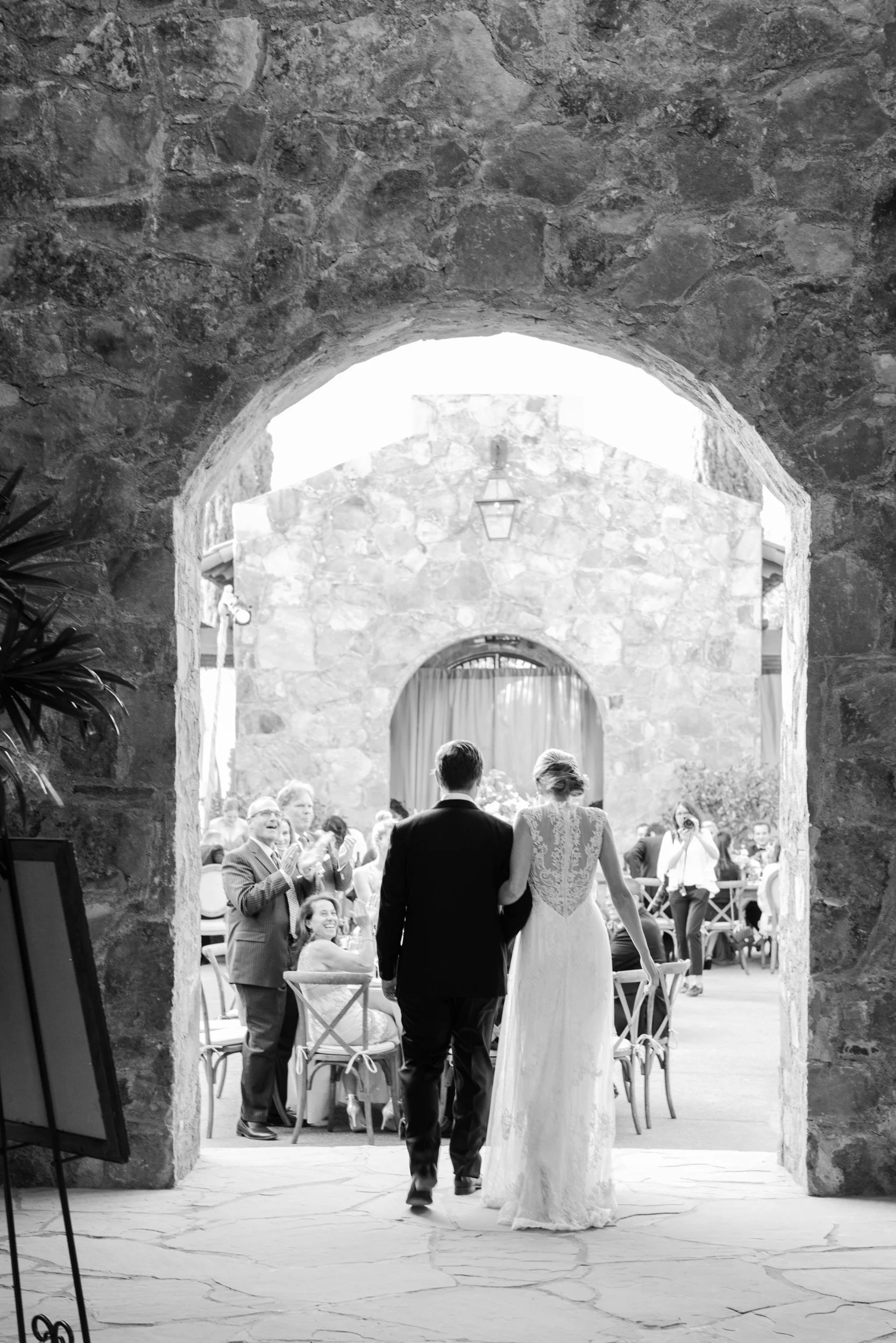 Bride and groom enter outdoor wedding reception in Calistoga Ranch; Sylvie Gil Photography