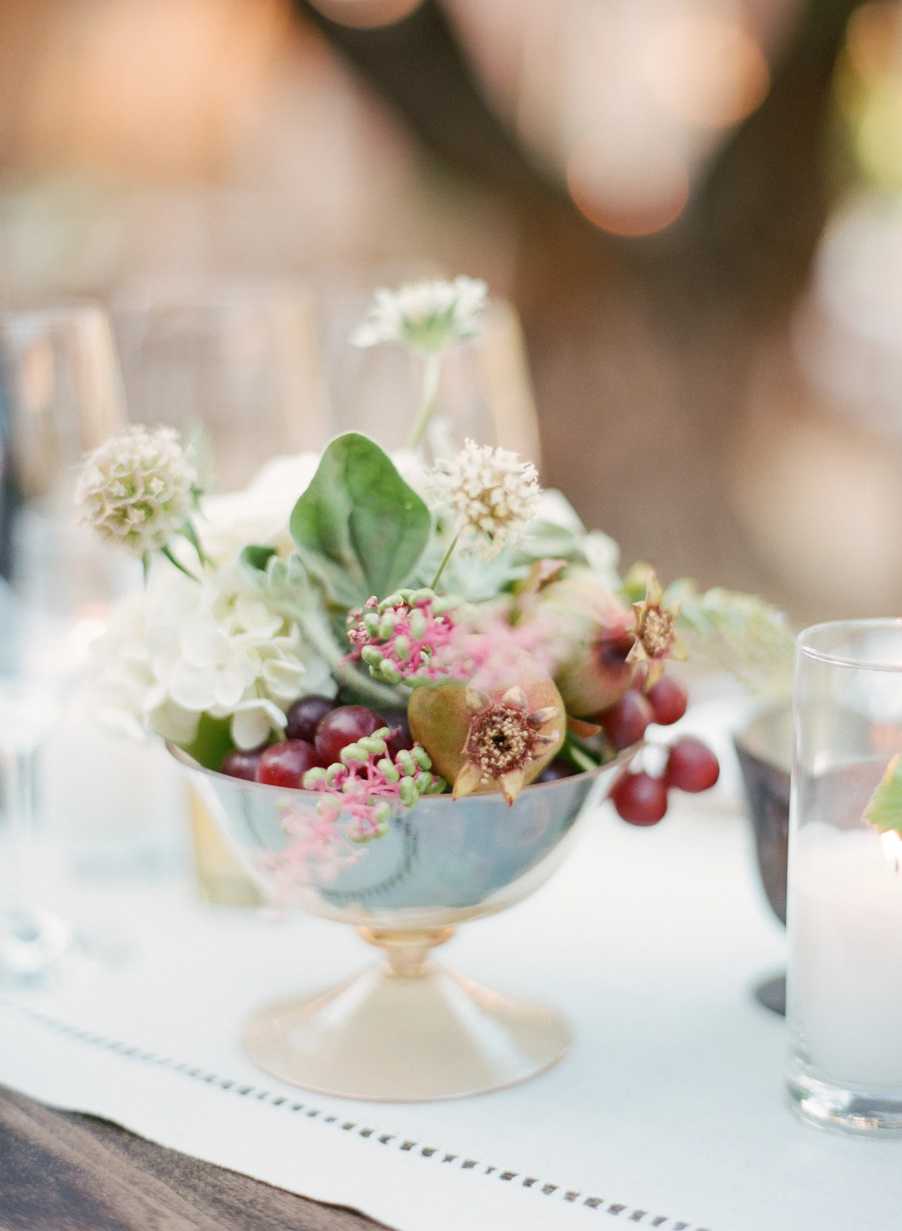 Fruit and floral centerpieces at the outdoor reception in Calistoga Ranch; Sylvie Gil Photography