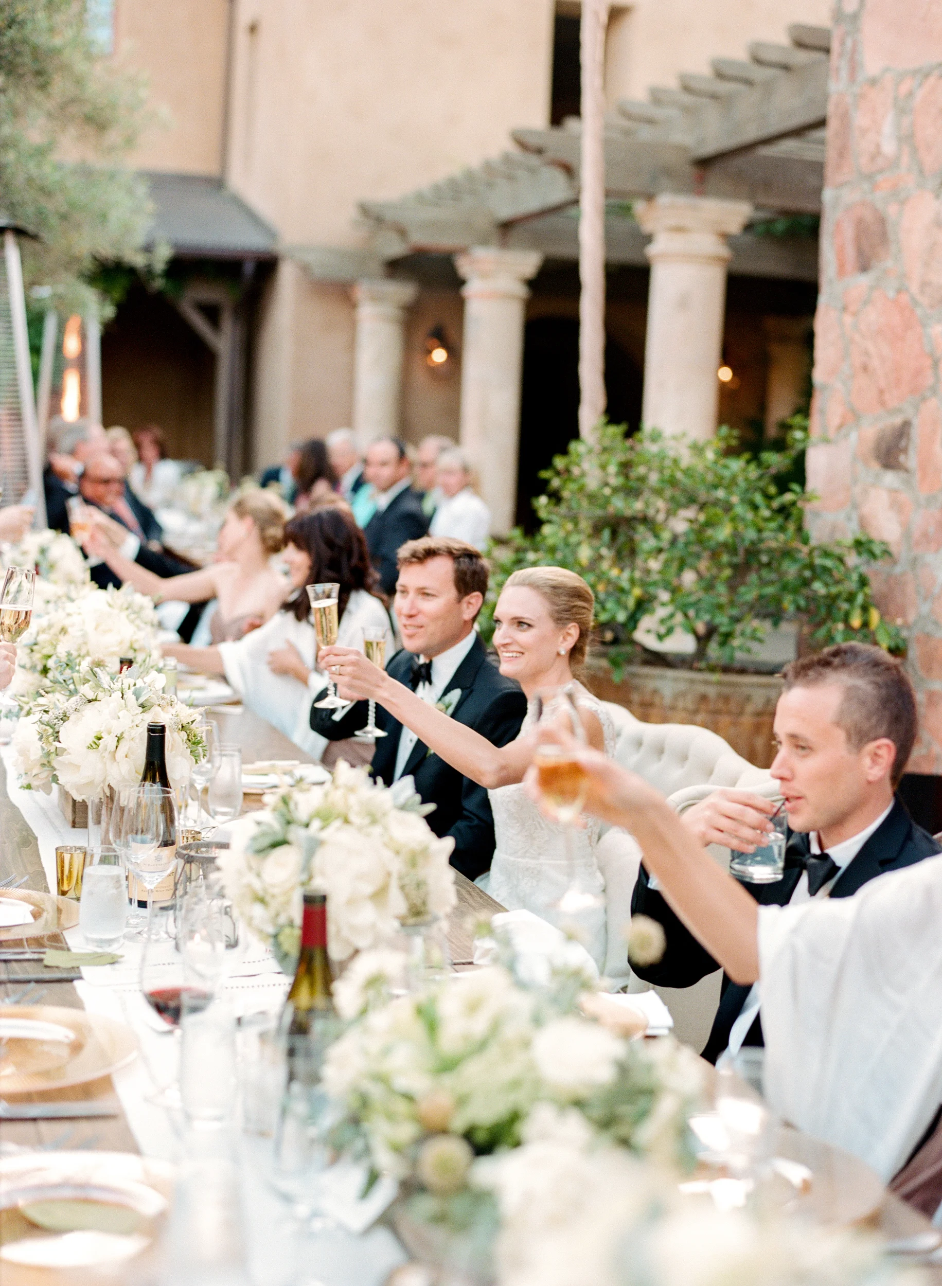 Bride and groom toast champagne at the outdoor reception in Calistoga Ranch; Sylvie Gil Photography