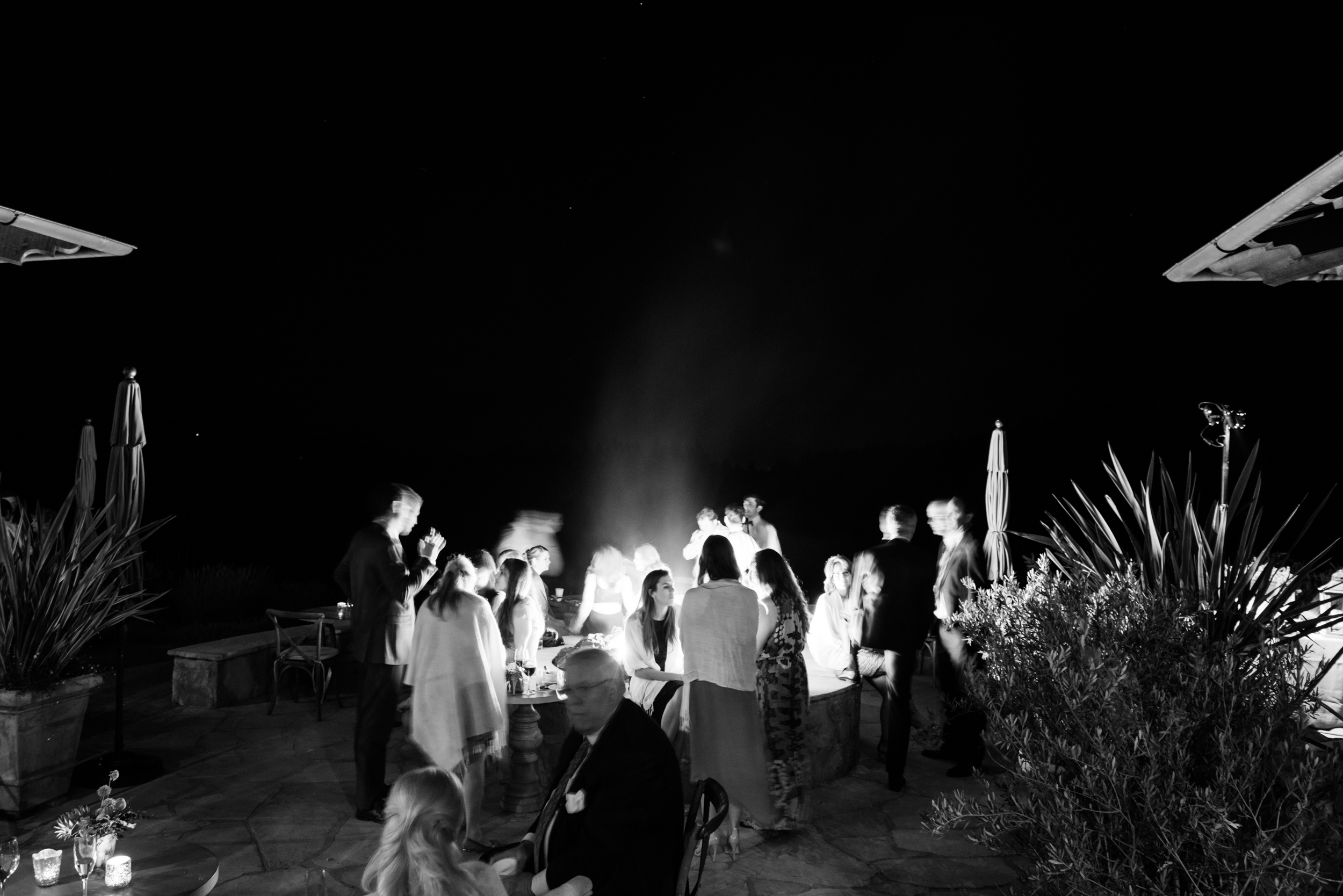 Guests gather around a fire pit at the Calistoga Ranch outdoor reception; Sylvie Gil Photography