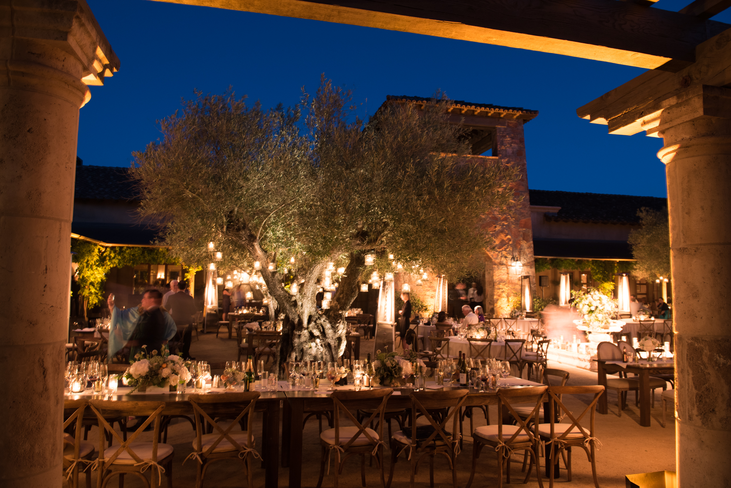 Tea lights hang from olive trees in the Calistoga Ranch courtyard reception; Sylvie Gil Photography