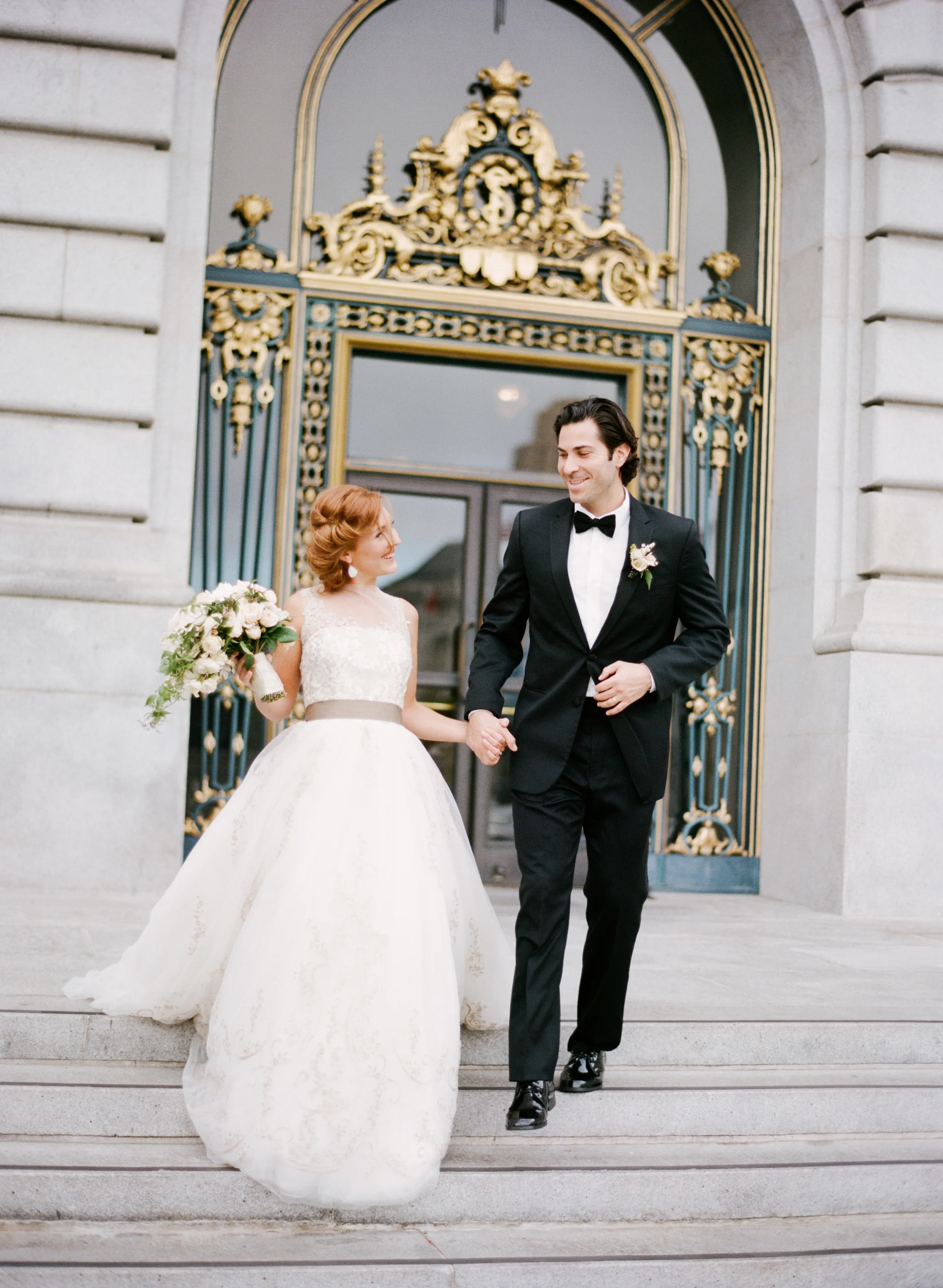 A French couple walks out of San Francisco City Hall just married; Sylvie Gil Photography