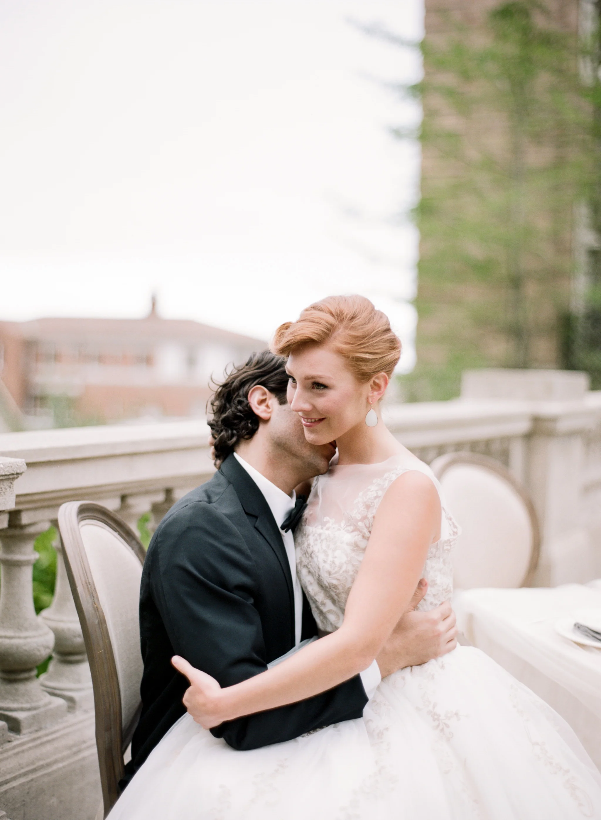 A groom kisses his bride's neck at an intimate wedding reception at the Lyon Steps in San Francisco; Sylvie Gil Photography