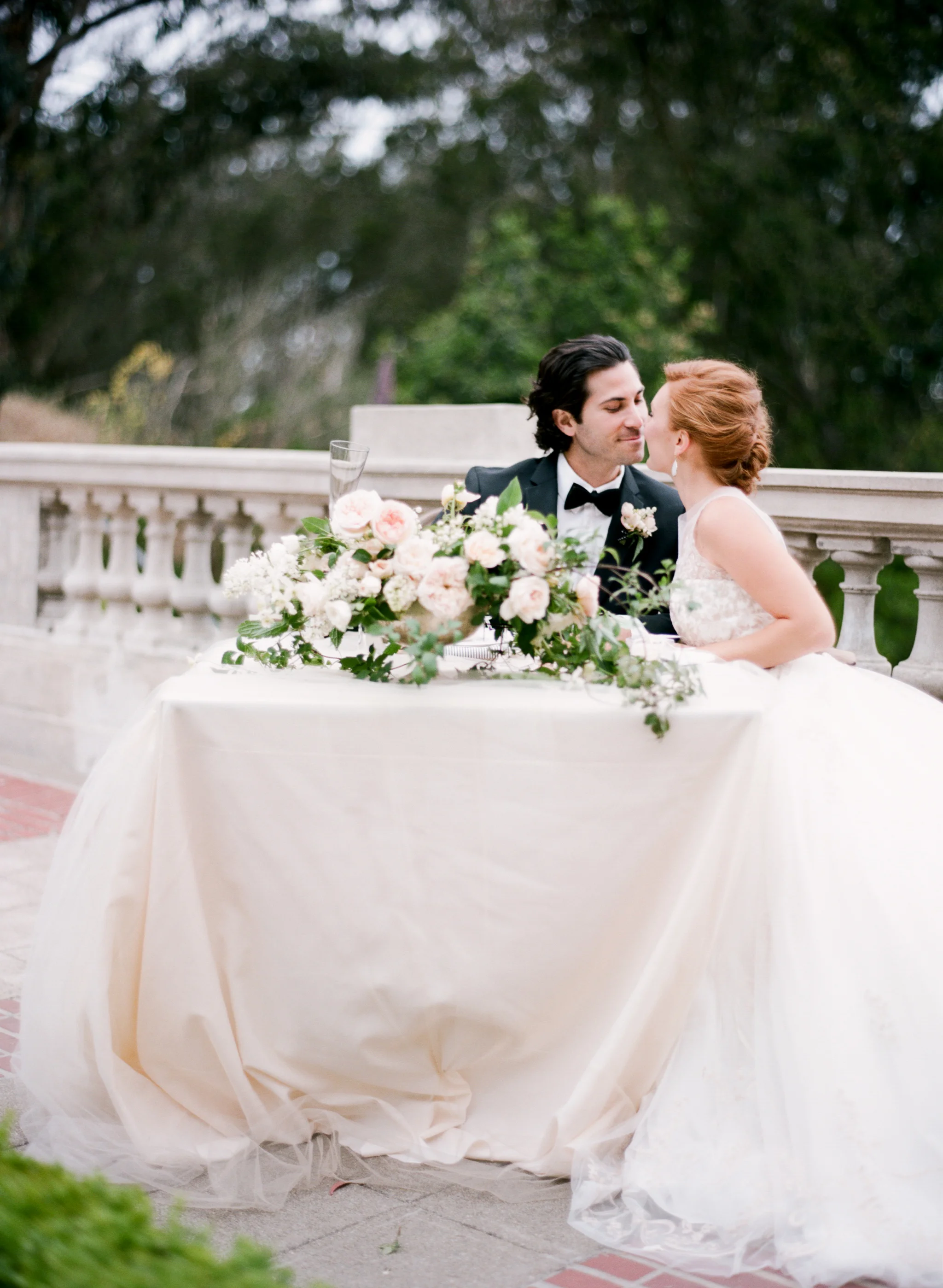 Bride and groom share a kiss at an intimate wedding reception at Lyon Steps near the Presidio in San Francisco; Sylvie Gil Photography
