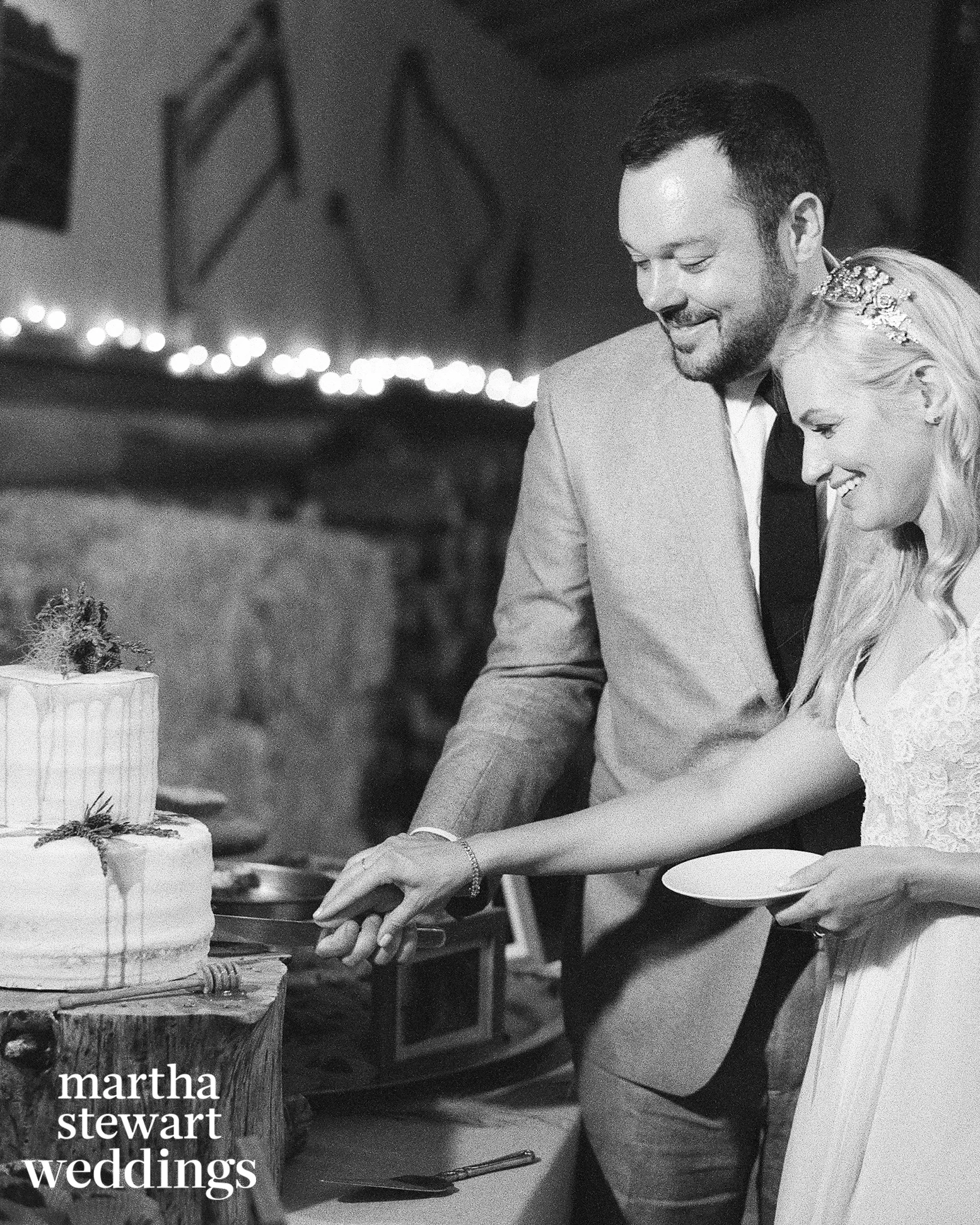 Famous couple cuts the cake for their wedding in a barn in wyoming, Sylvie Gil Photography