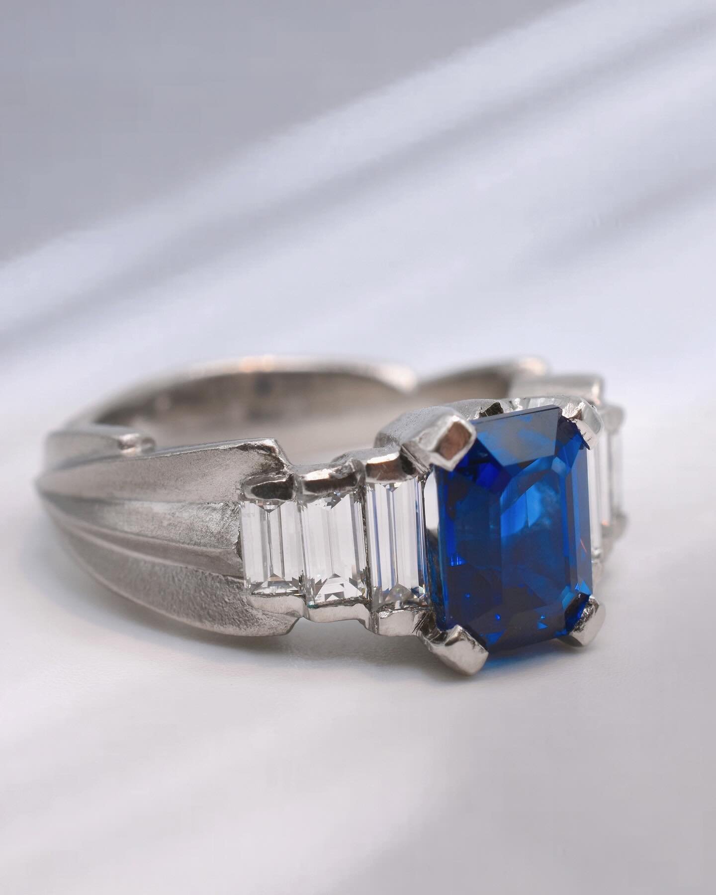a very special custom Art Deco inspired engagement ring with an emerald cut sapphire and baguette side diamonds 💙
