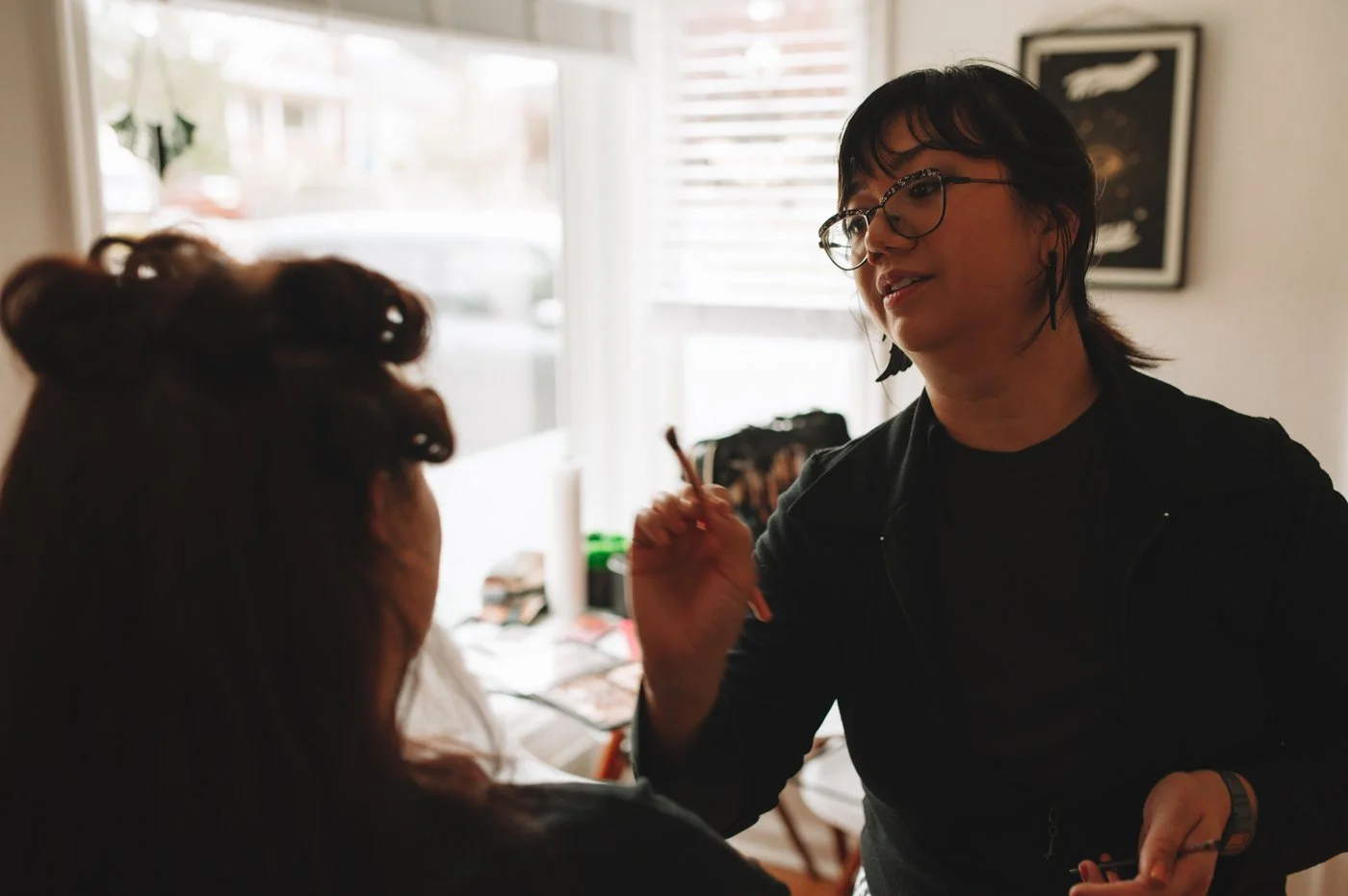 Hair and Makeup artist applies lip liner to Portland Boudoir client