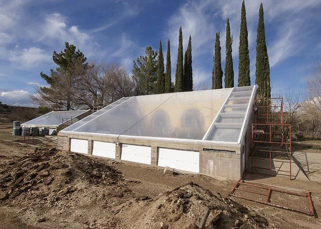 Arcosanti test greenhouses, via Flickr user A. Thompson . Note faint white ring in lower right; that is the internal tensioner pushing the plastic out in the middle to keep it taut.