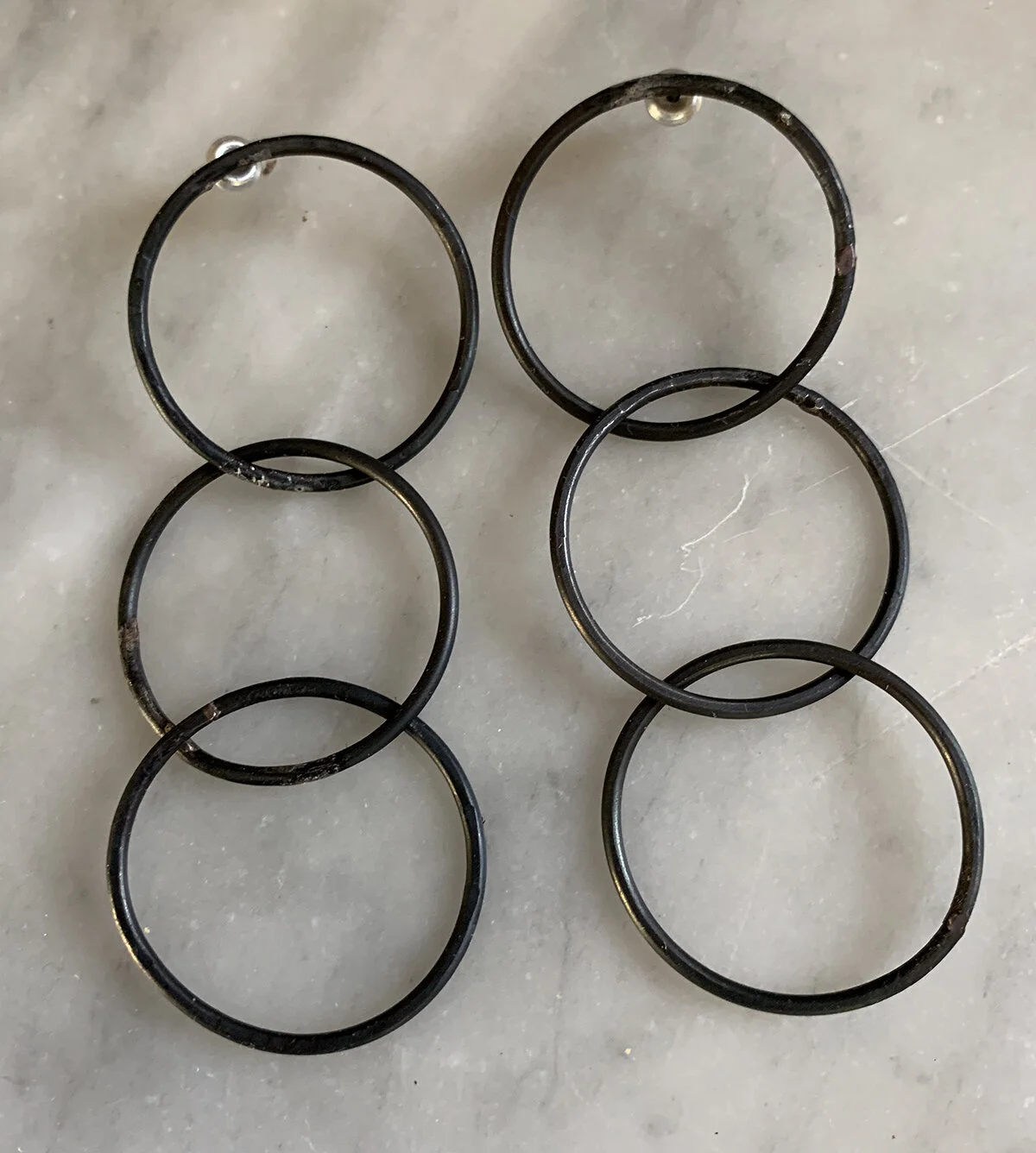 Three circles of mild steel make up these lightweight earrings with sterling silver posts.