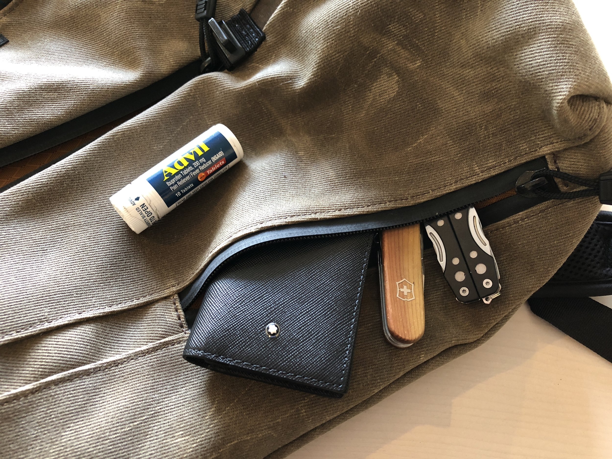 Outside pockets hold business cards, tools, a charger and Advil.